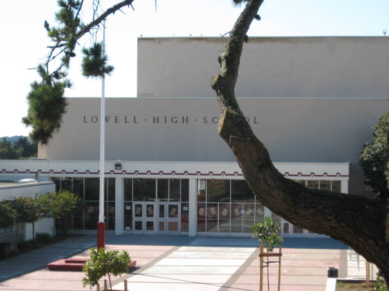 An exterior view of Lowell High School, a gray, boxy building.