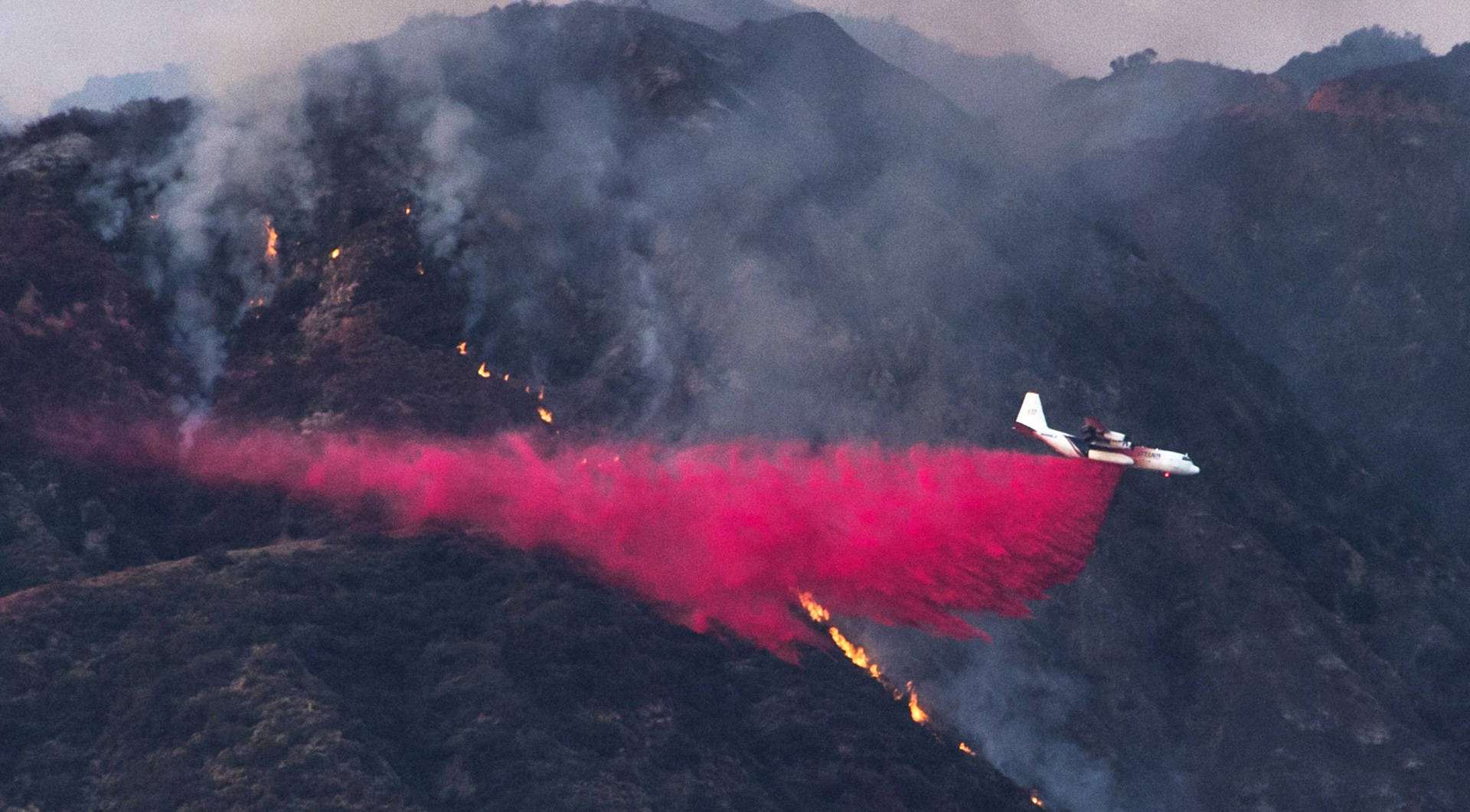An aircraft drops fire retardant to prevent the advance of the San Gabriel Complex Fire in the Angeles National Forest, near Duarte on June 21, 2016. Robyn Beck/AFP/Getty Images