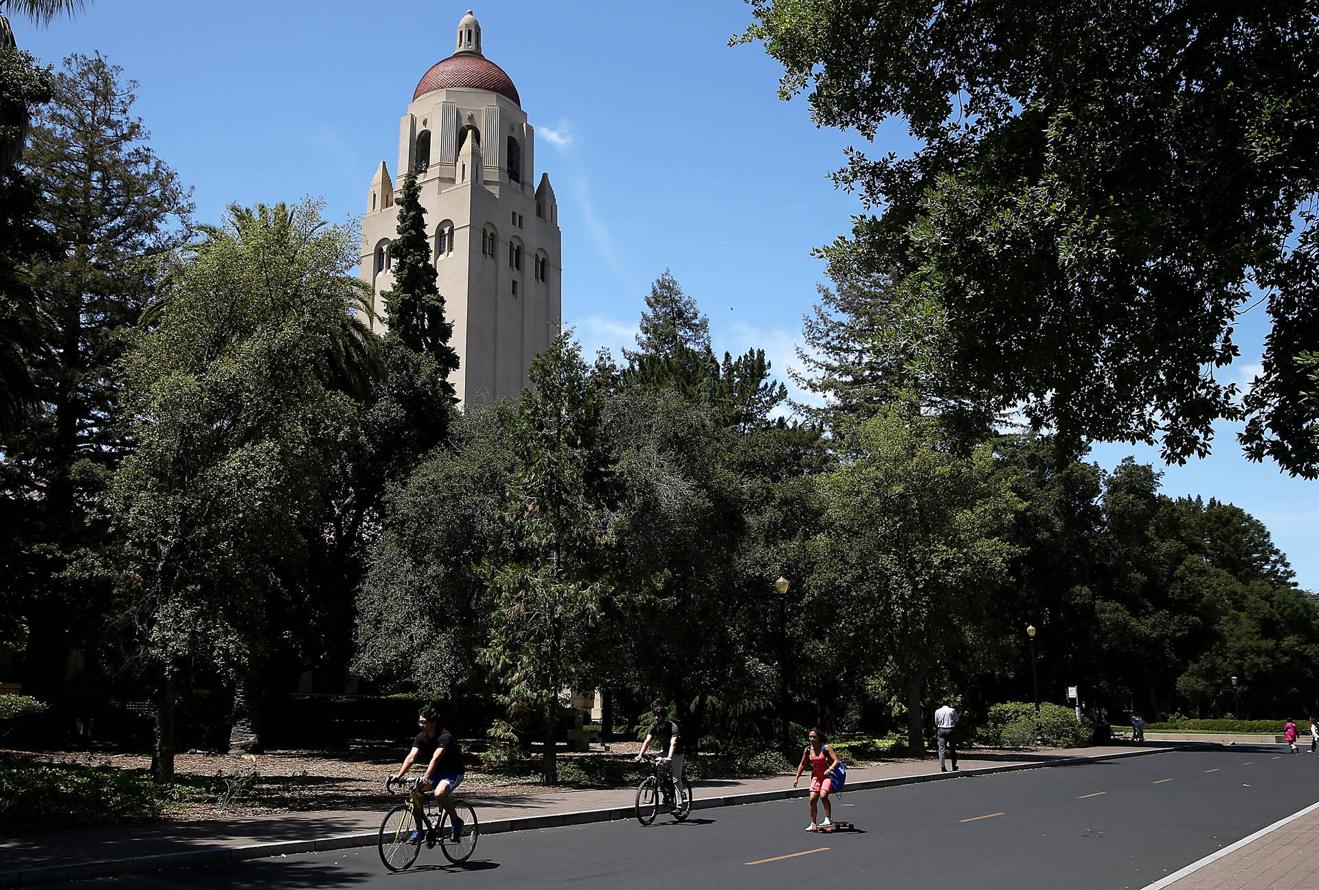 People ride bikes past Hoover Tower on the Stanford University campus. Justin Sullivan/Getty Images