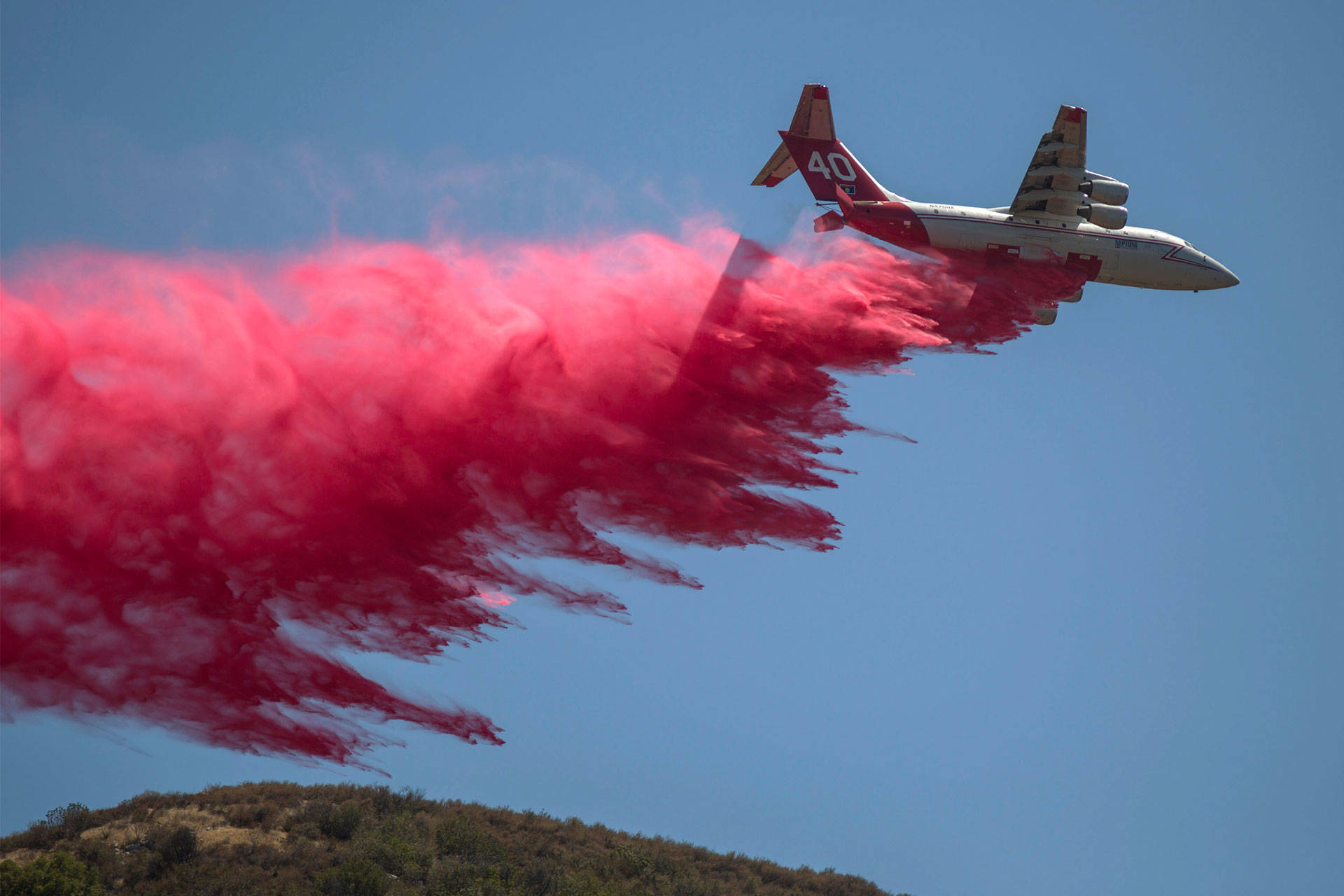 A firefighting air tanker drops fire retardant on the Sand Fire in Placerita Canyon on July 25, 2016 in Santa Clarita. David McNew/Getty Images