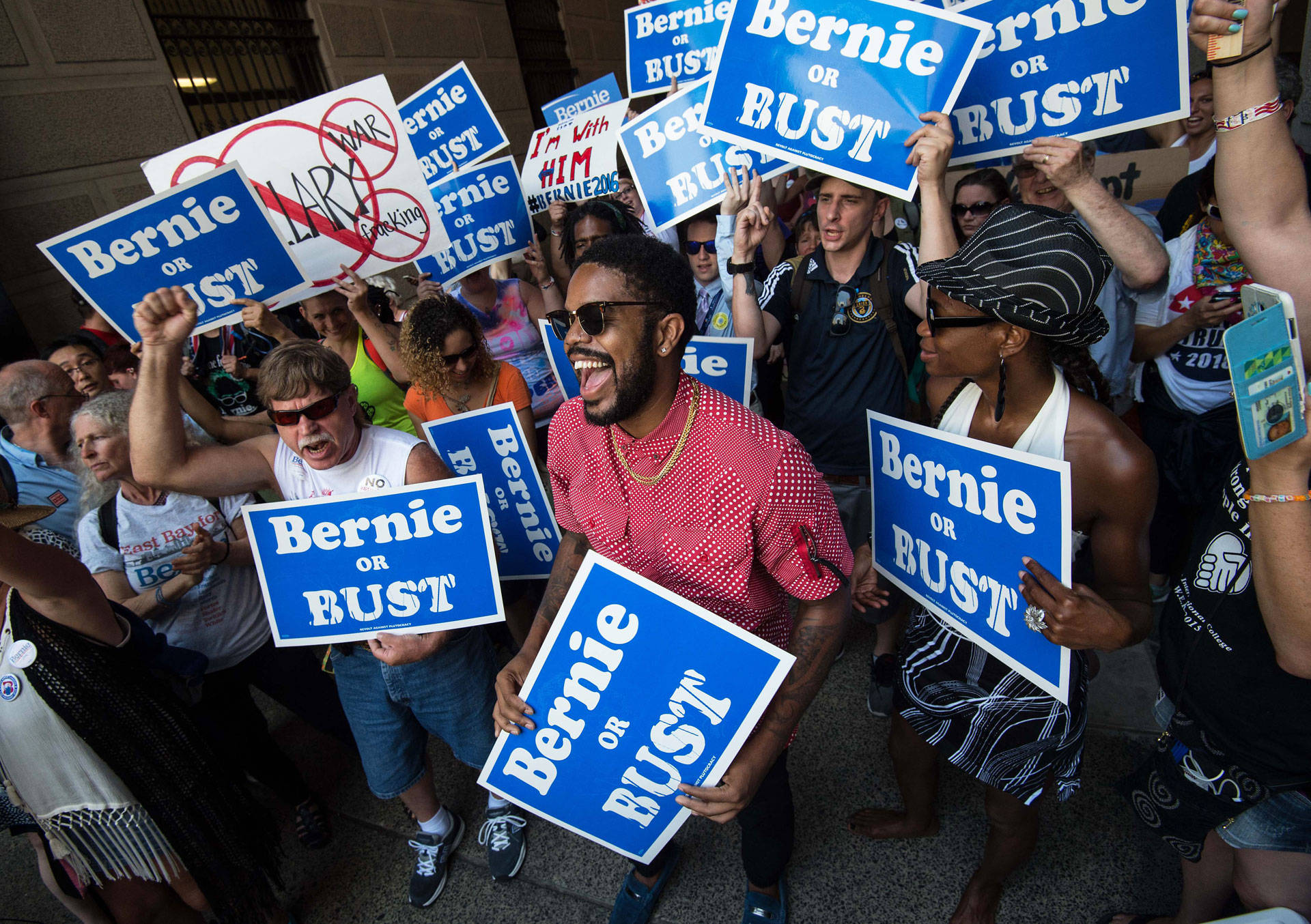 Supporters of Bernie Sanders hold signs at a rally at City Hall in Philadelphia on July 25, 2016.  Nicholas Kamm/AFP/Getty Images
