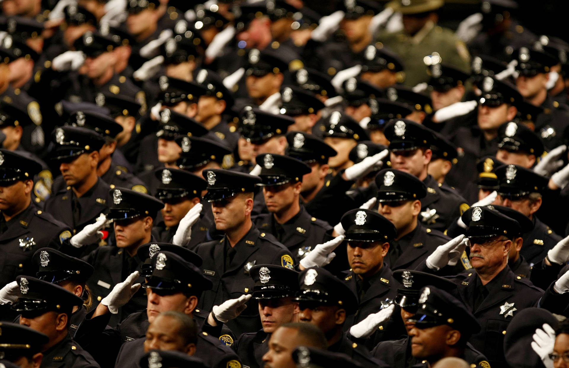  Members of the Oakland Police Department salute at the public memorial service for slain Oakland police officers Sgt. Mark Dunakin, 40; John Hege, 41; Sgt. Ervin Romans, 43; and Sgt. Daniel Sakai, 35, on March 27, 2009.  Michael Macor/Pool-Getty Images