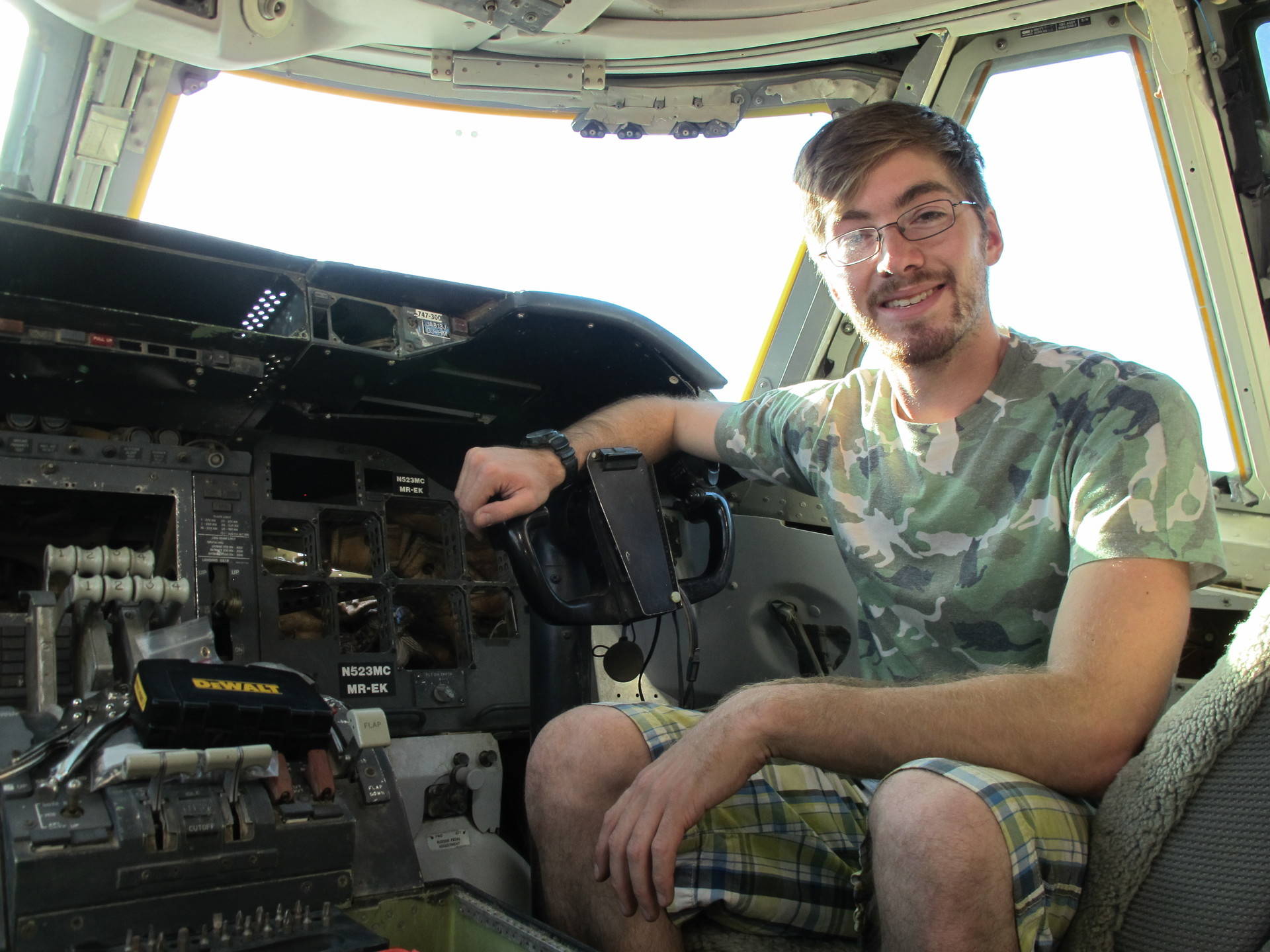 Volunteer Nick Avila of San Francisco sits in the 747 cockpit that he's helping to fix up for Burning Man. Susan Valot/KQED