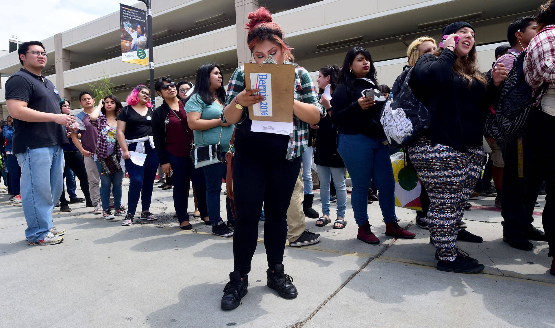 Wendy Hic fills out her voter registration form as students wait in line for their forms at an East Los Angeles College 'Rock the Campus for Bernie' event in Monterey Park on May 10, 2016.  Frederic J. Brown/AFP/Getty Images