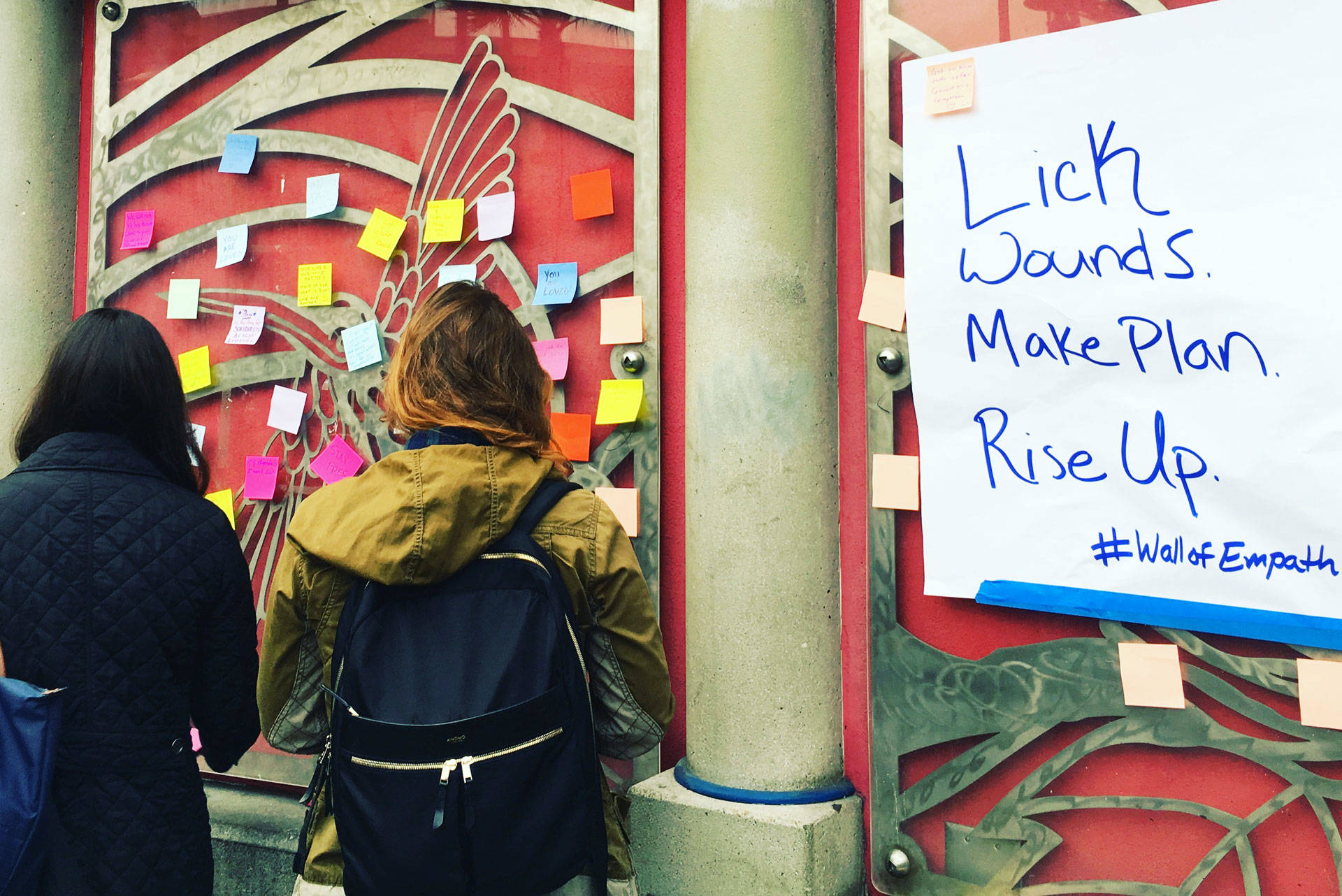 People write messages of support following Donald Trump's election victory on the walls at the 16th Street BART Station in San Francisco on Monday, Nov. 14. Rachel Roberson/KQED