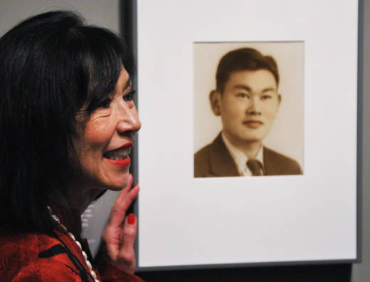 Karen Korematsu poses next to a photograph of her father Fred Korematsu during a presentation of his portrait to the National Portrait Gallery on February 2, 2012 in Washington, D.C.