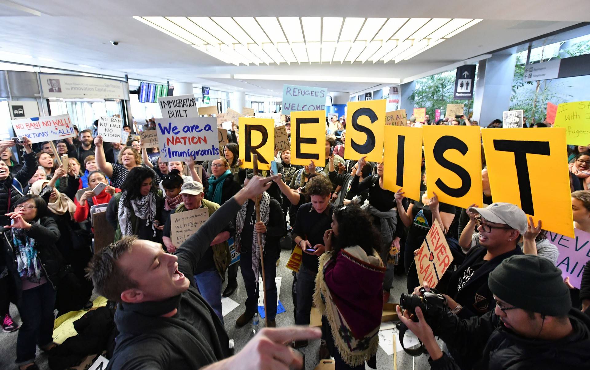 Protesters hold signs up during a protest at San Francisco International Airport in San Francisco, California on January 29, 2017. JOSH EDELSON/AFP/Getty Images