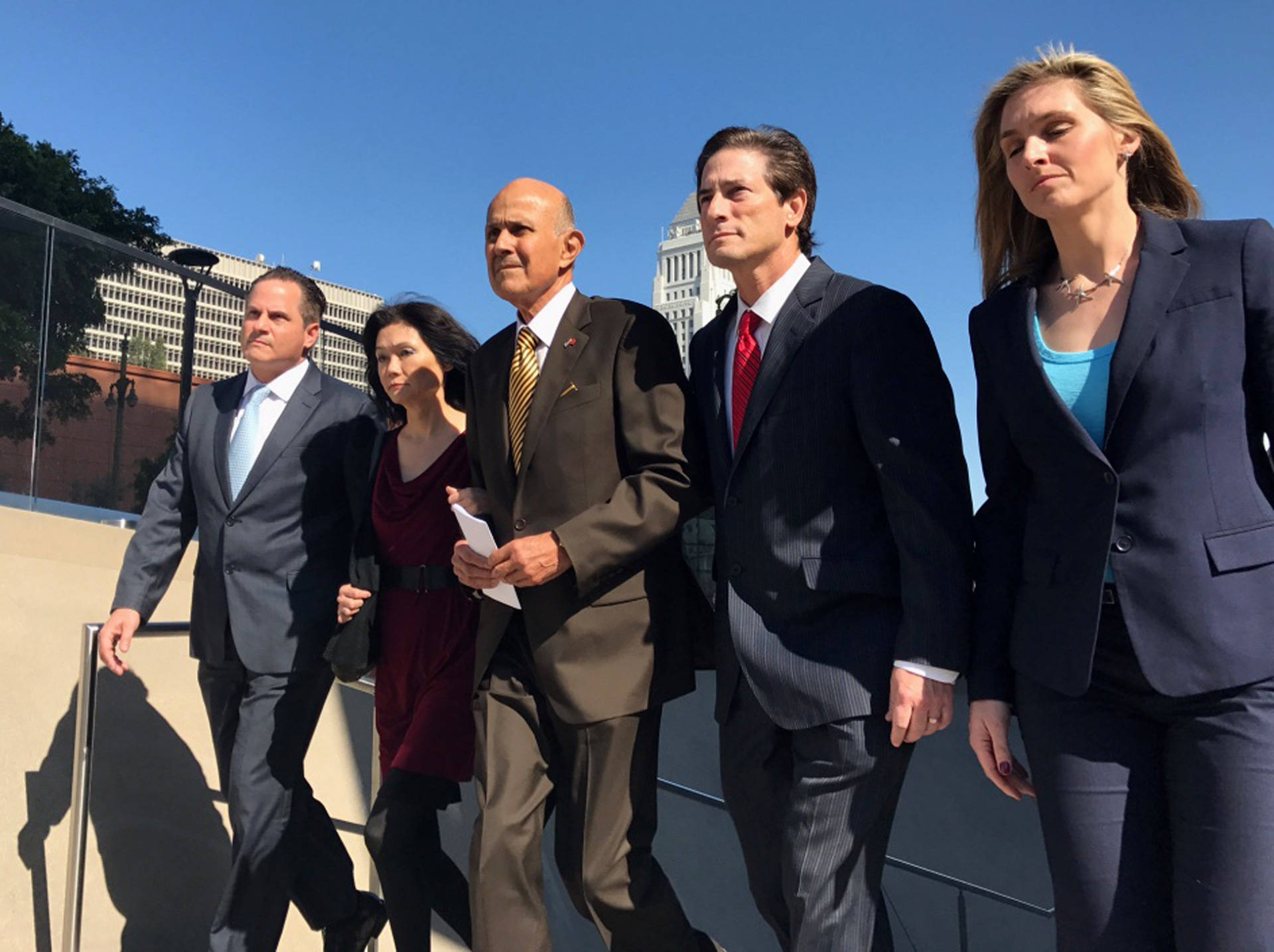 Former L.A. County Sheriff Lee Baca (C) leaves the federal courthouse after being convicted of lying, conspiracy and obstructing an FBI investigation into inmate abuse in the jails. Annie Gilbertson/KPCC