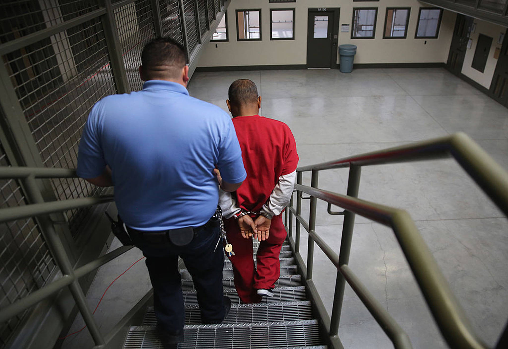 A guard escorts an immigrant detainee at the Adelanto Detention Facility, the largest Immigration and Customs Enforcement detention center in California. John Moore/Getty Images