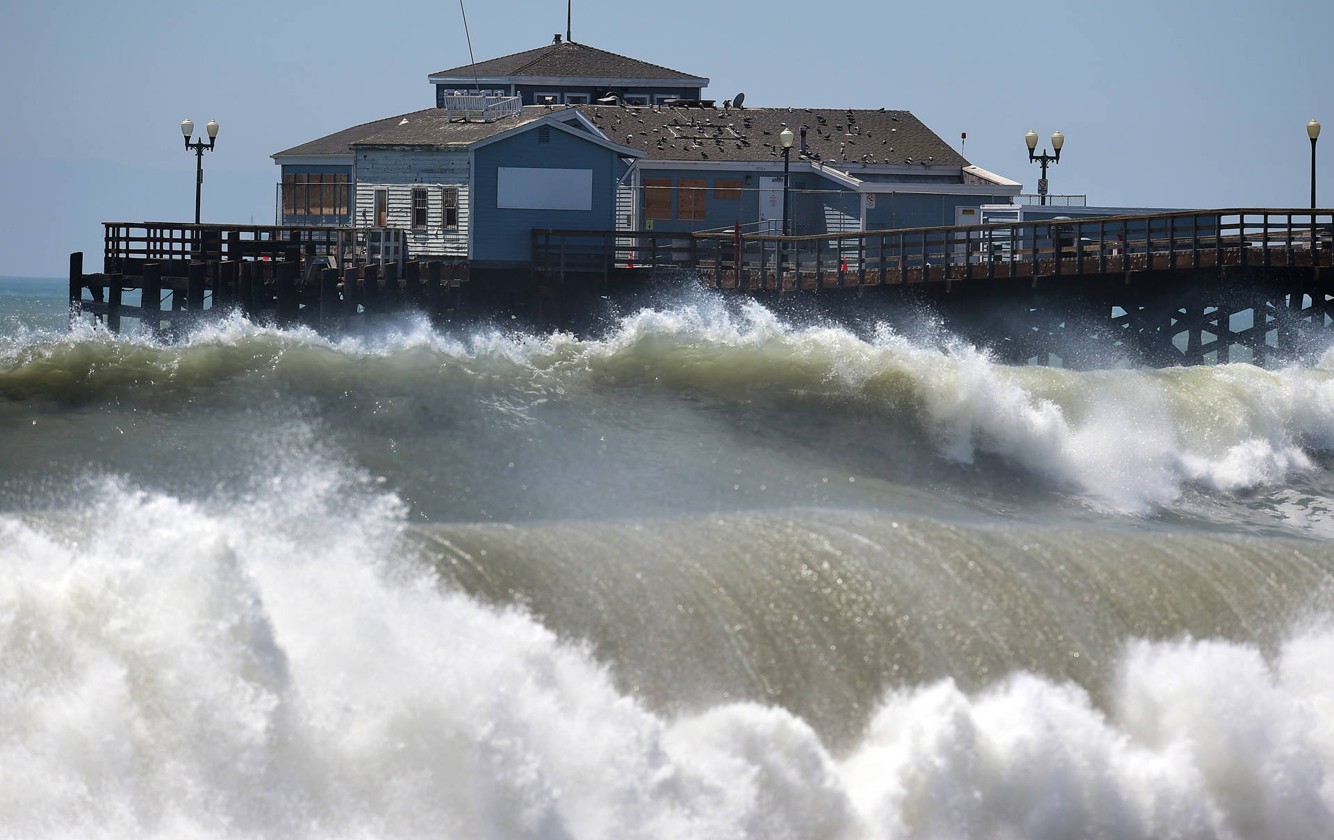 Large waves crash ashore and into the pier at Seal Beach in 2014. FREDERIC J. BROWN/AFP/Getty Images