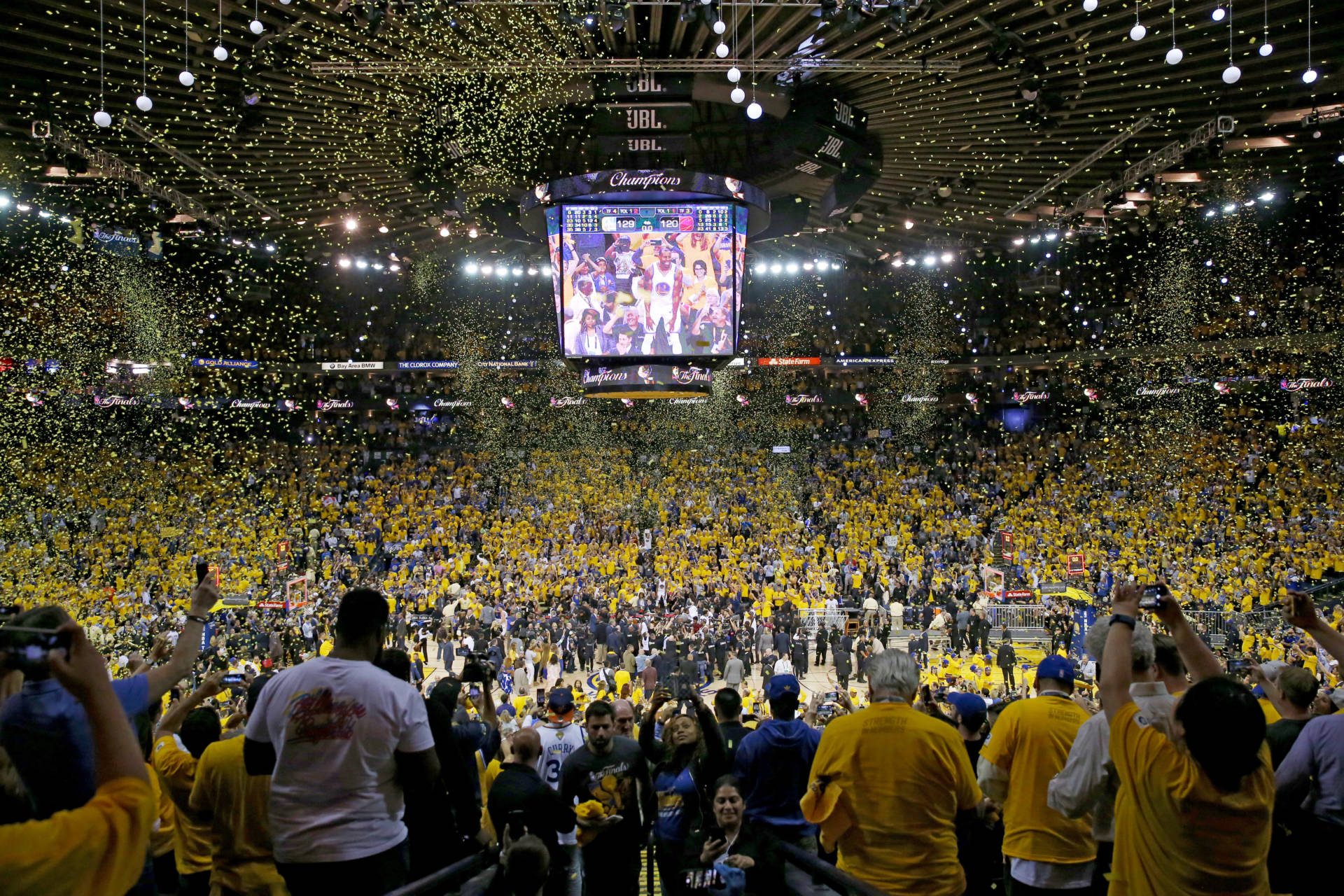 Fans cheer inside Oracle Arena as the Golden State Warriors celebrate their second NBA title in three seasons. Ezra Shaw/Getty Images