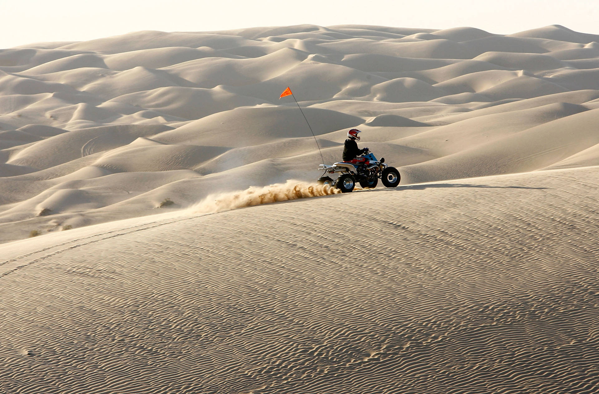 An ATV driver rides in the Colorado Desert at the Imperial Sand Dunes, also known as the Algodones Dunes. Imperial County firefighters and police officers patrol the area, and are partially compensated through the federal PILT program, which President Trump's budget would slash. David McNew/Getty Images