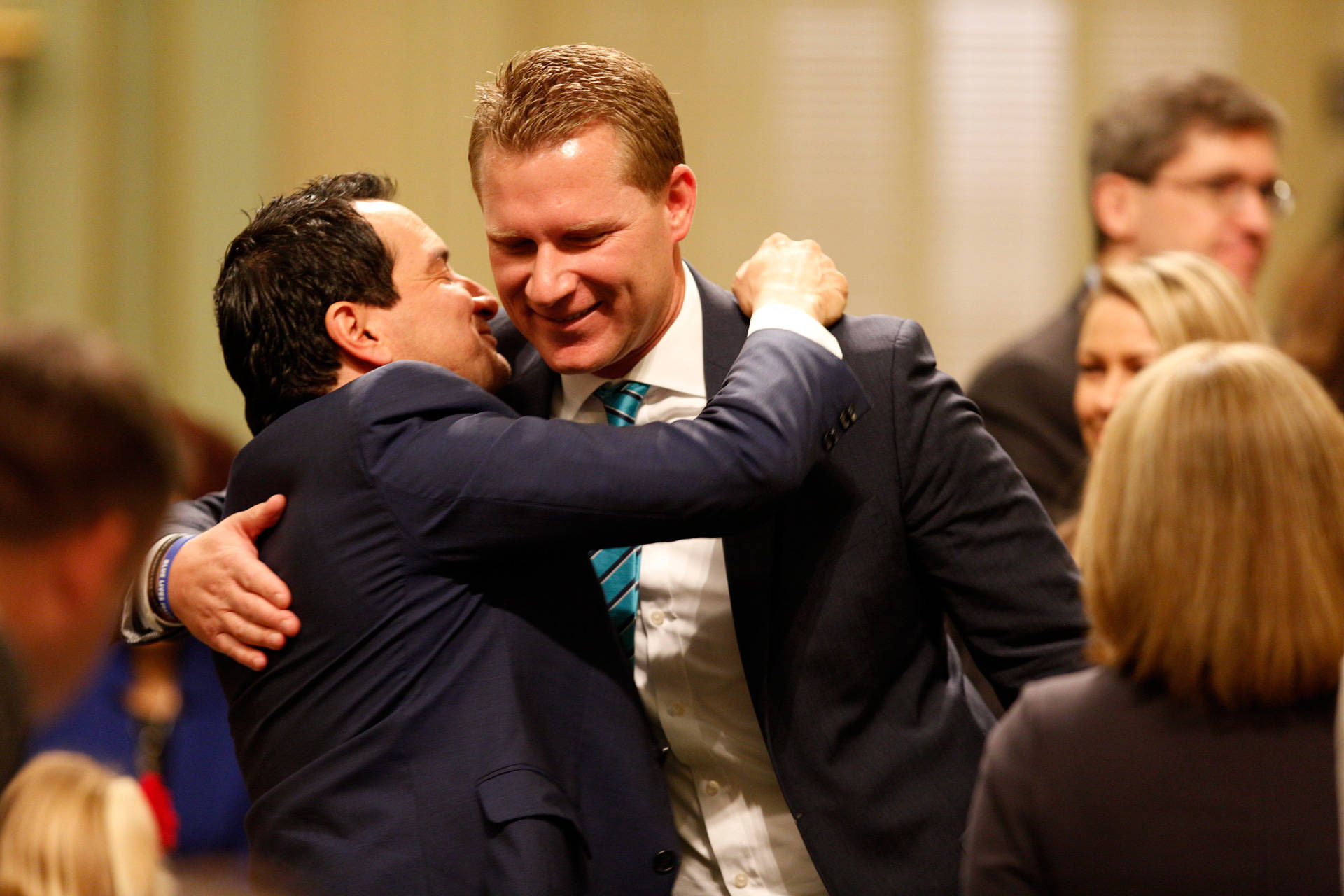Democratic Assembly Speaker Anthony Rendon (L) embraces former Assembly GOP leader Chad Mayes in December, 2016. Steve Yeater/CALmatters