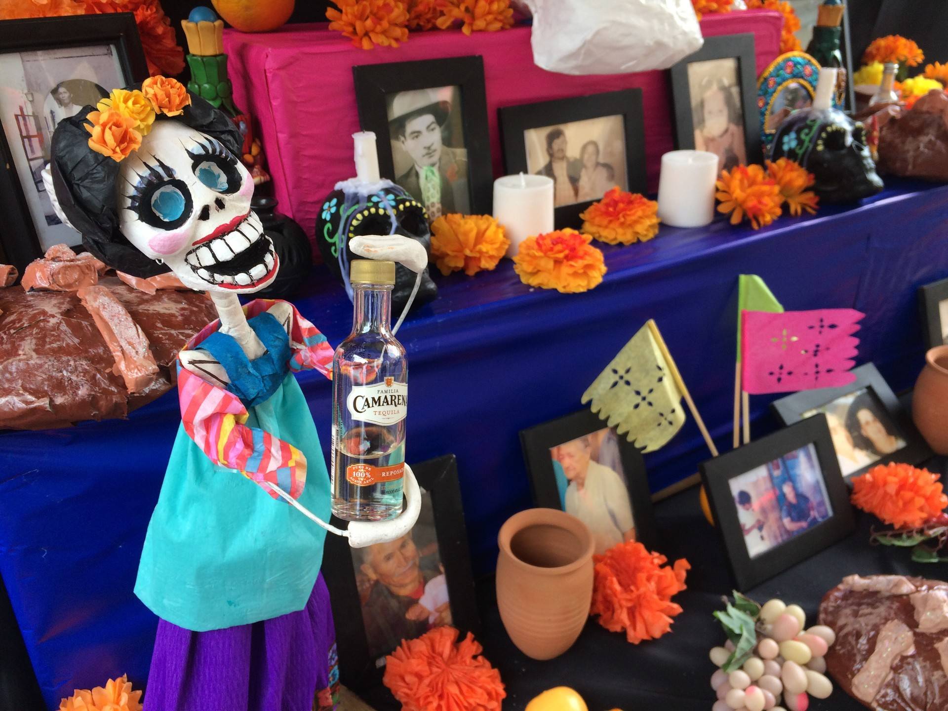 Artist Andrea Luna adorned her altar with  "Amor Eterna," which depicts a calavera holding the favorite drink of deceased loved one. Tiffany Camhi/KQED