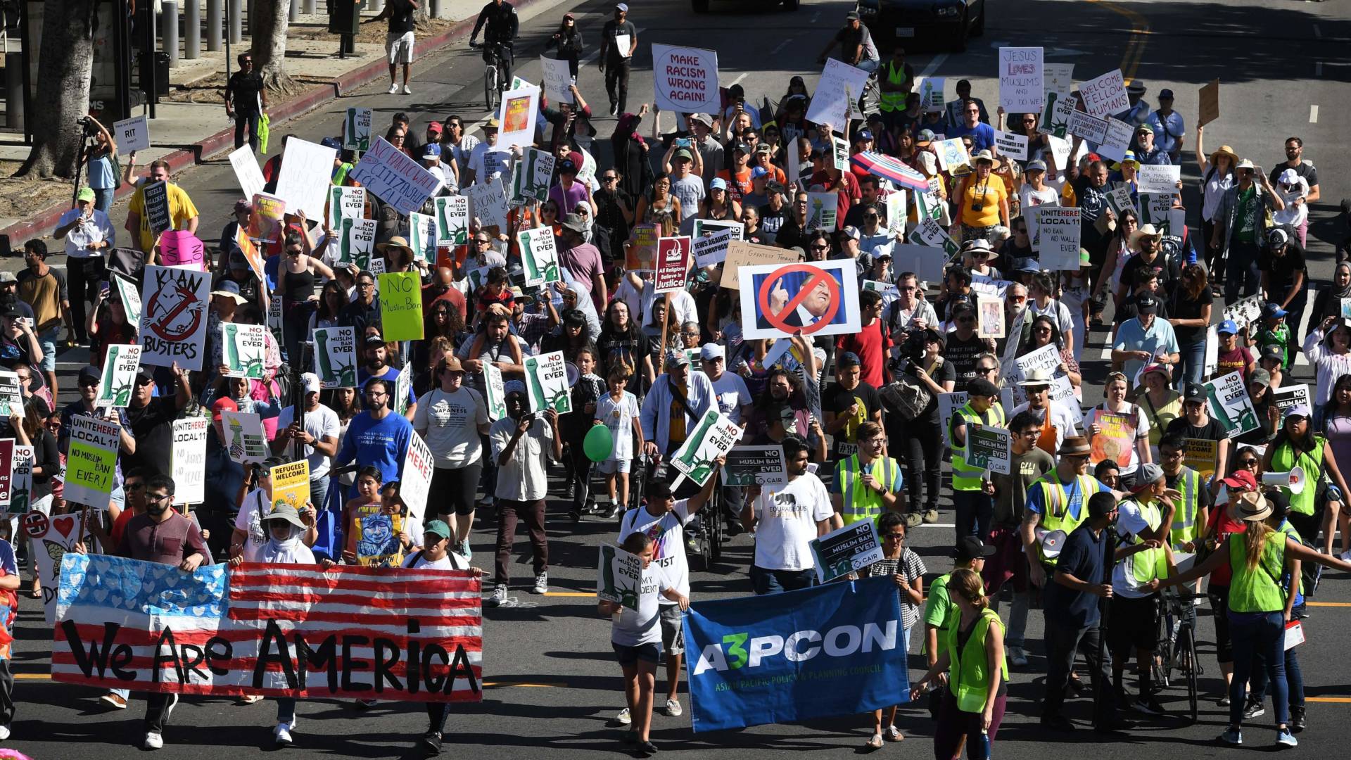 People march as they participate in the '#NoMuslimBanEver' rally in downtown Los Angeles on Sunday. The march organized by the Council on American-Islamic Relations was in response to President Trump's most recent travel ban, which has now been blocked by a federal judge in Hawaii. Mark Ralston/AFP/Getty Images