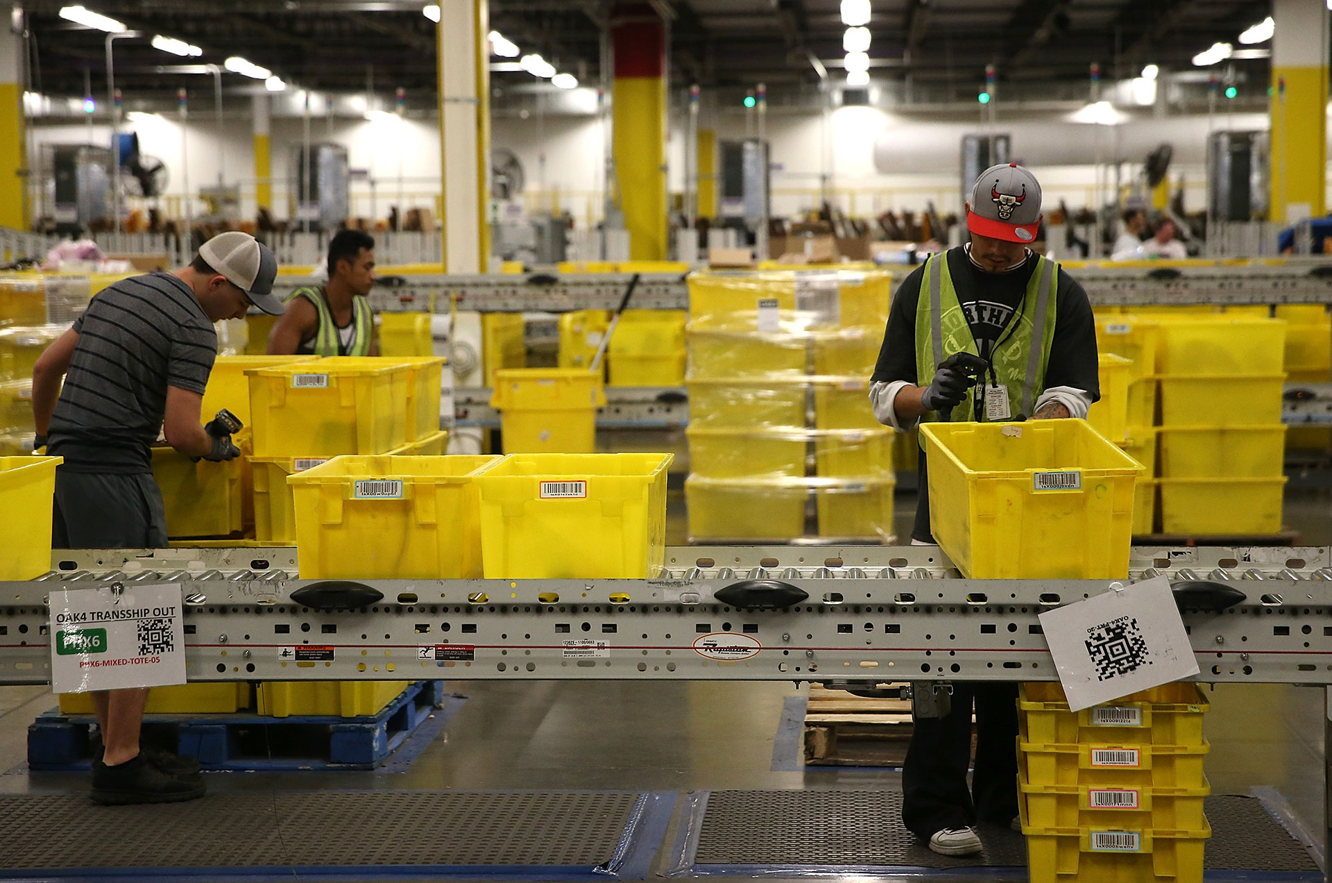 Workers pack orders at an Amazon fulfillment center in Tracy.