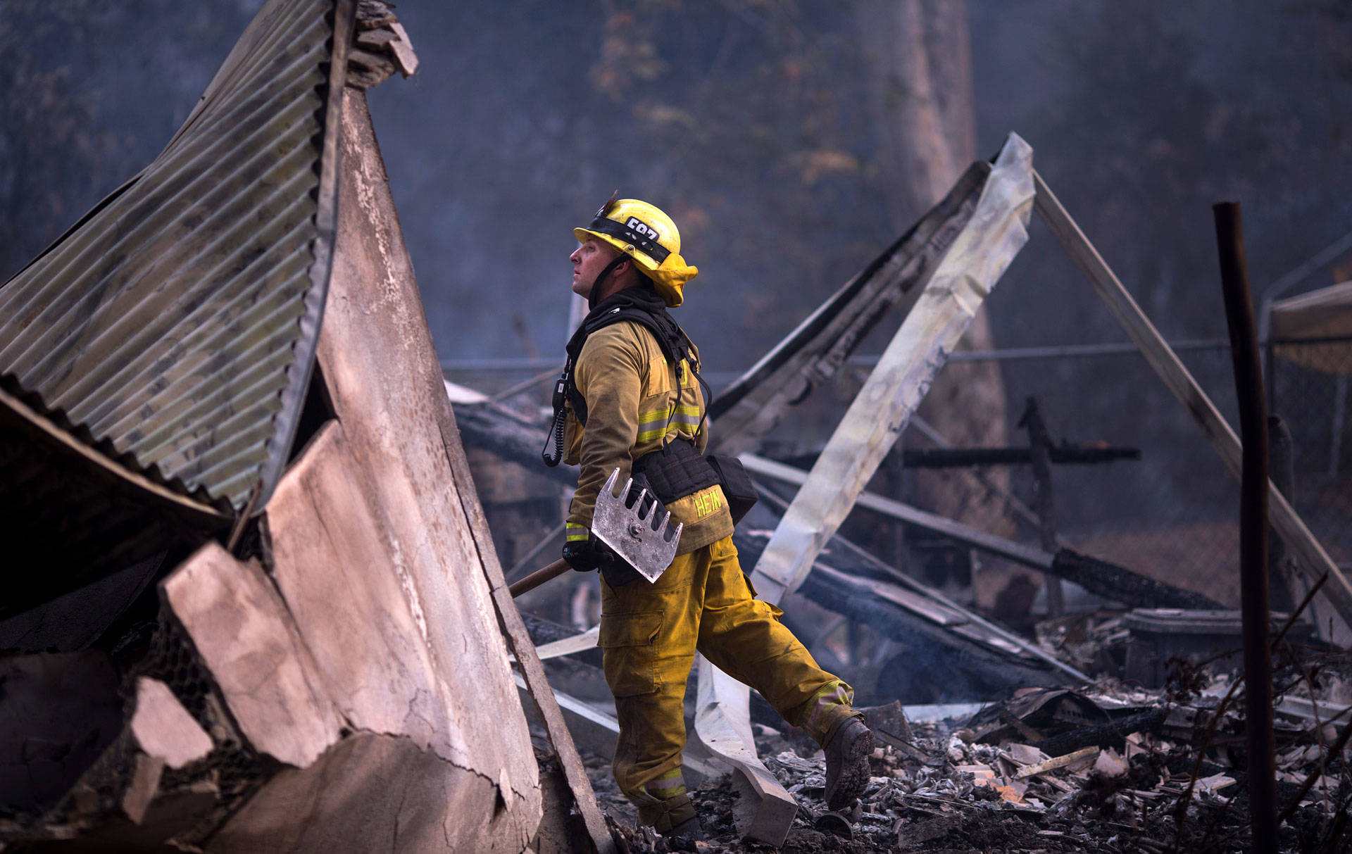 A firefighter looks through the smoldering ruins of a burned house near Casitas Pass Road, as the Thomas Fire continued to grow on Dec. 10, 2017, near Carpinteria.  David McNew/Getty Images