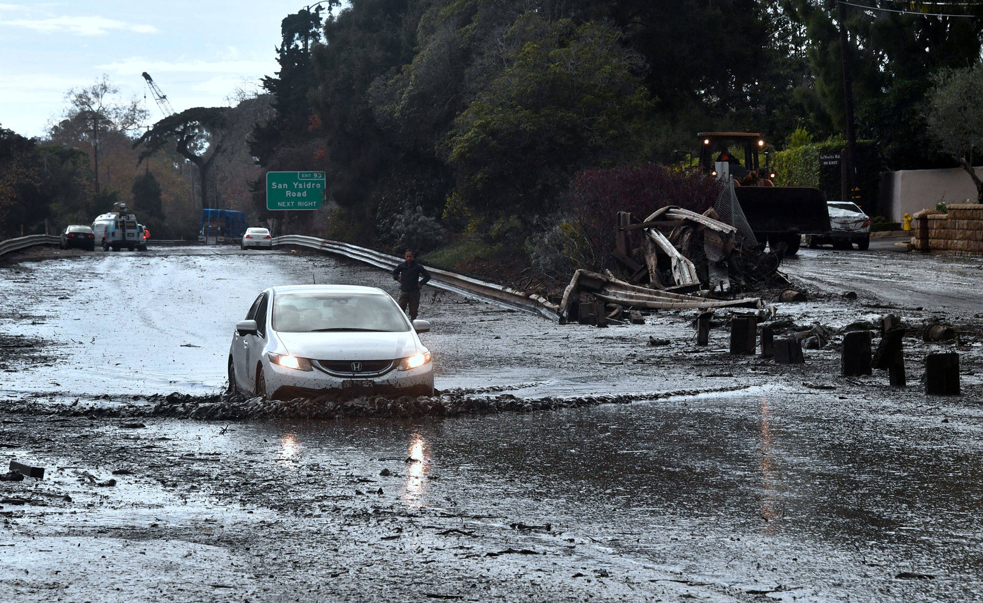 A vehicle drives across the flooded US 101 freeway in Montecito on January 9, 2018. FREDERIC J. BROWN/AFP/Getty Images