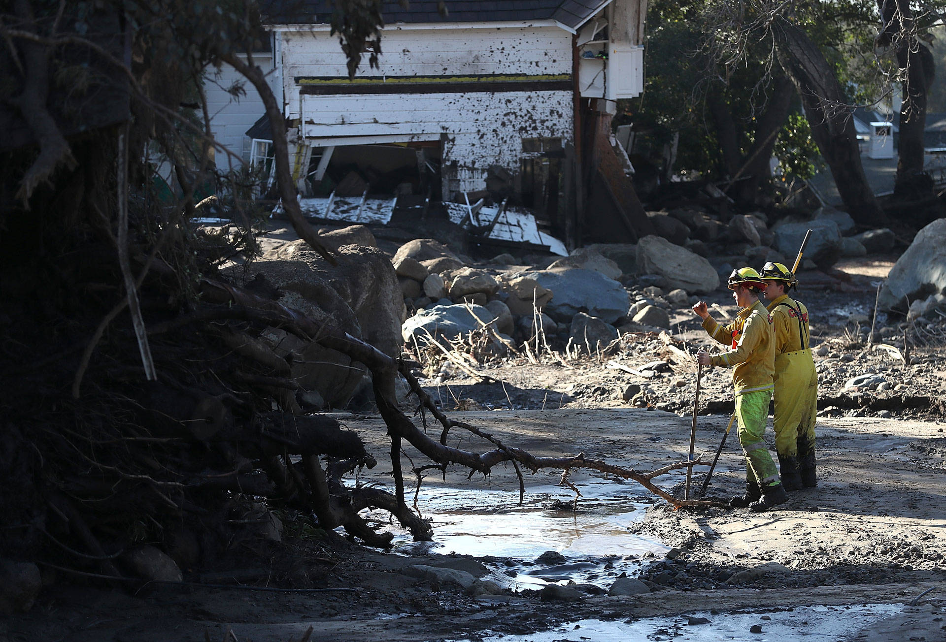 Cal Fire firefighters search a neighborhood on Jan. 12, 2018, in Montecito that was destroyed by a mudslide. Justin Sullivan/Getty Images