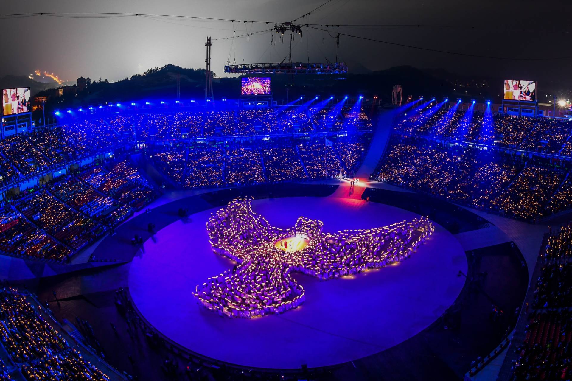 More than 1,200 people, including 1,000 residents of Gangwon province, form the shape of a dove out of candlelight during the opening ceremony. Francois-Xavier Marit/AFP/Getty Images