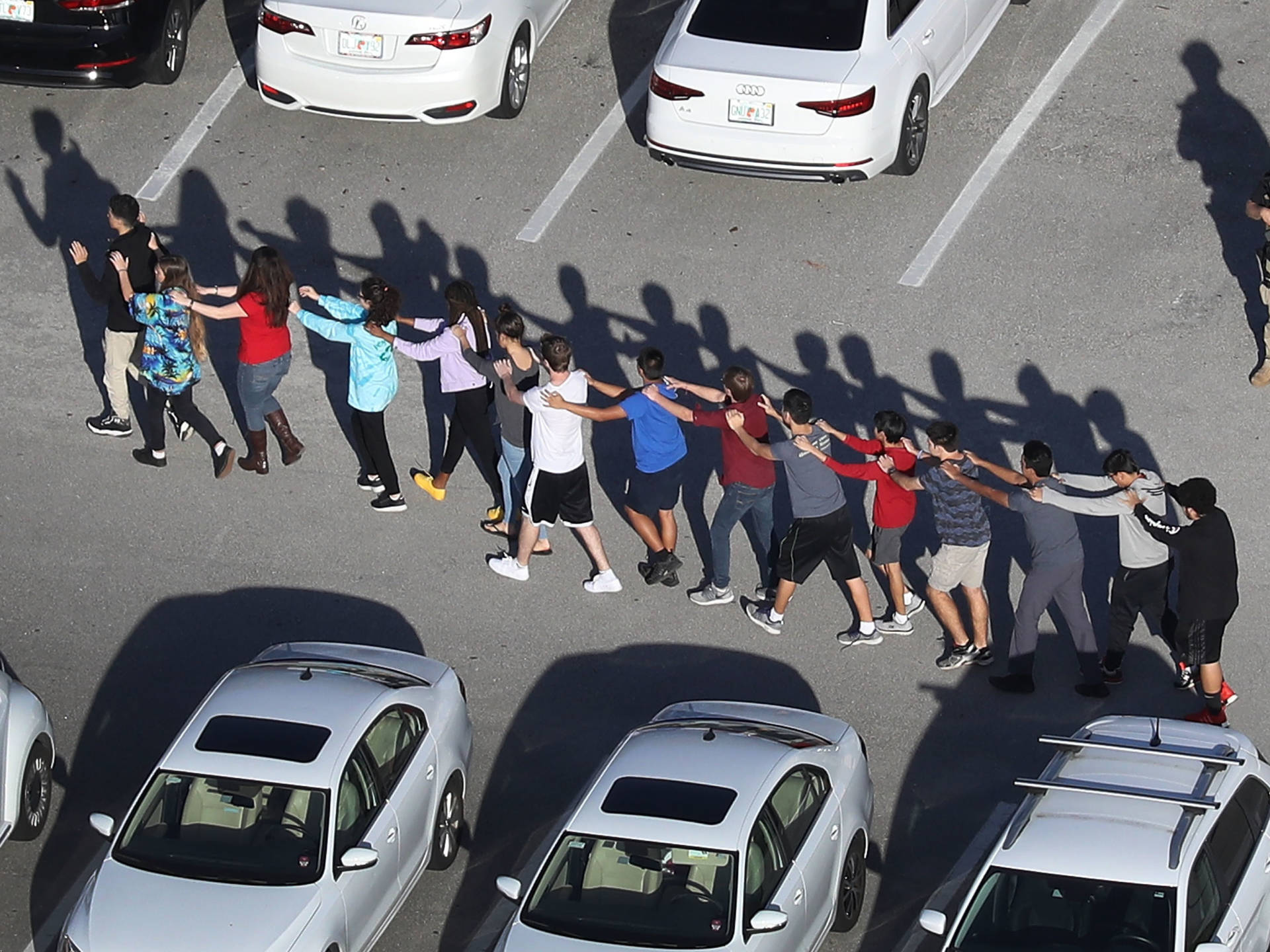People are brought out of the Marjory Stoneman Douglas High School after a shooting at the school that killed at least 17 people on Wednesday in Parkland, Florida. Joe Raedle/Getty Images