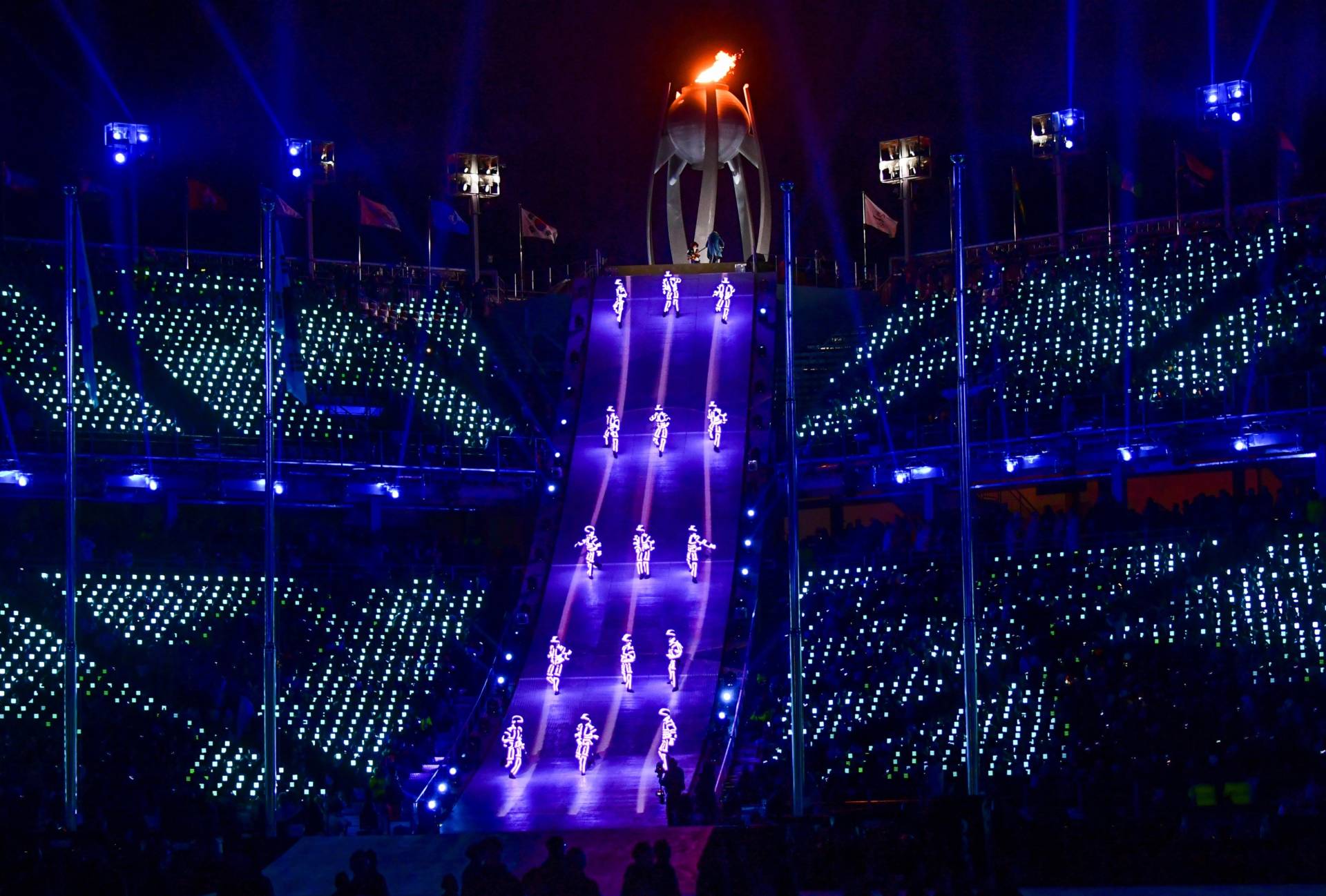 Artists perform near the Olympic flame during the closing ceremony. "Although parting is sad, we will remember Pyeongchang with beautiful memories," said Lee Hee-beom, the Pyeongchang Olympics organizing committee president.
 Martin Bernetti/AFP/Getty Images
