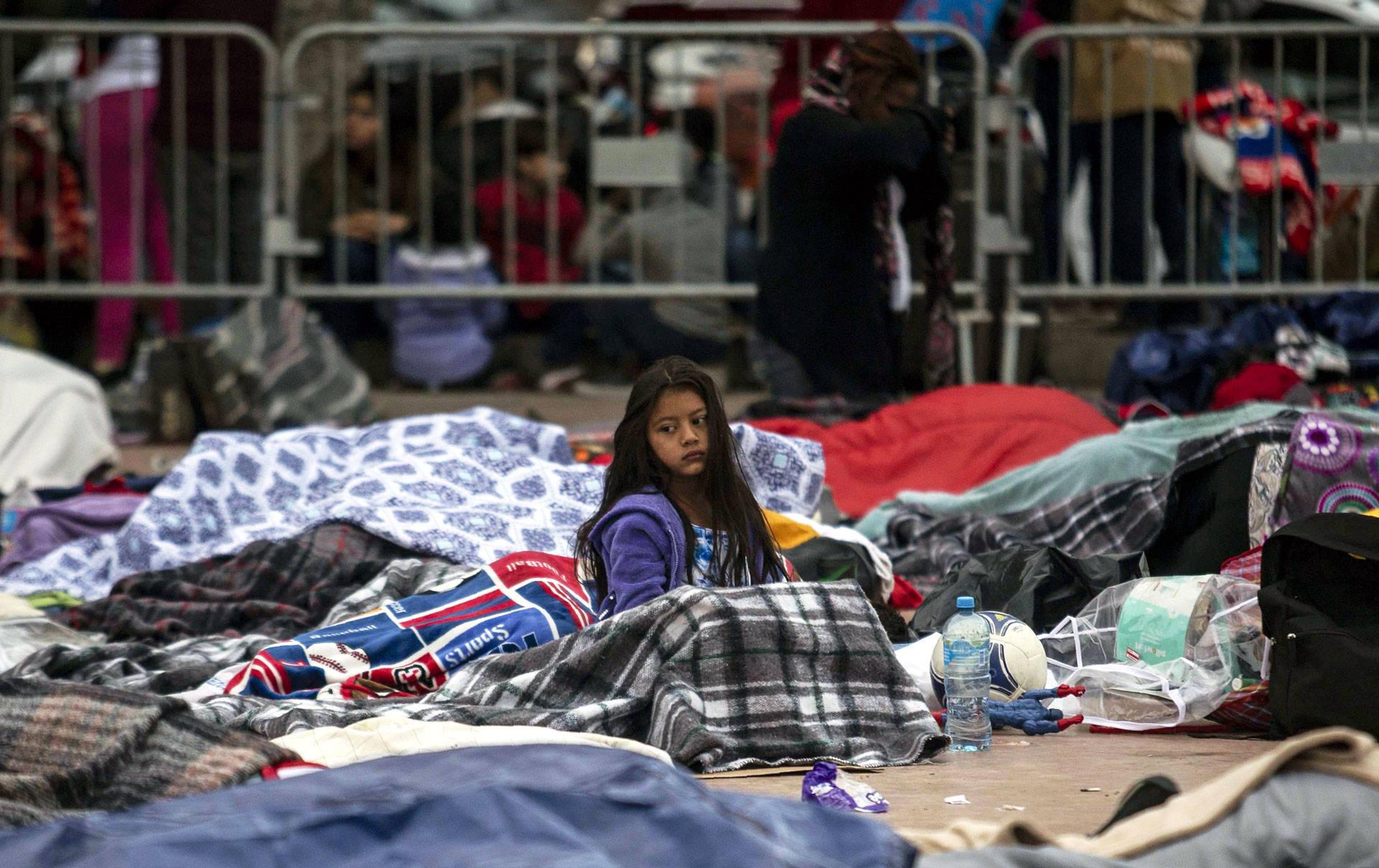 Central American migrants traveling in the 'Migrant Via Crucis' caravan sleep outside 'El Chaparral' port of entry to the U.S. while waiting to be received by U.S. authorities, in Tijuana, Mexico on April 30, 2018. GUILLERMO ARIAS/AFP/Getty Images