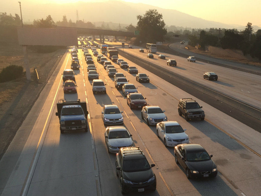 On Oct. 13, 2017, during the North Bay fires, cars slow during rush hour traffic on Highway 280 in Cupertino. Haze from the fires is visible in the air.  Isha Salian/Peninsula Press