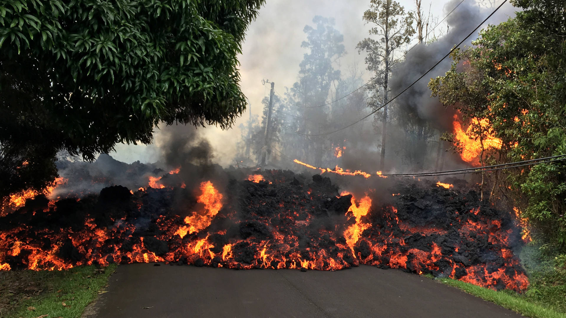 A lava flow moves on Makamae Street in the Leilani Estates subdivision on Sunday, following an eruption by Hawaii's Kilauea volcano. The governor of Hawaii has declared a local state of emergency and some 1,700 residents have been ordered to flee. U.S. Geological Survey/Getty Images