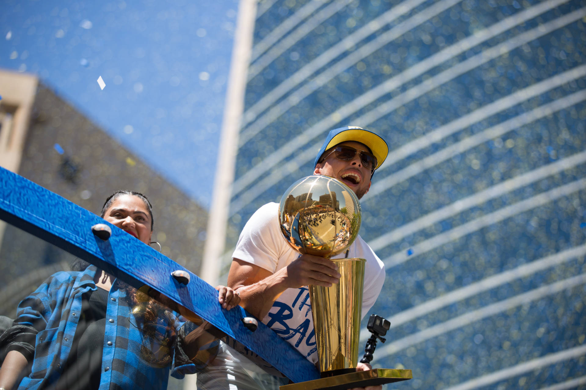 Stephen Curry carries the Larry O'Brien NBA Championship Trophy through the streets of Oakland.  Samantha Shanahan/KQED