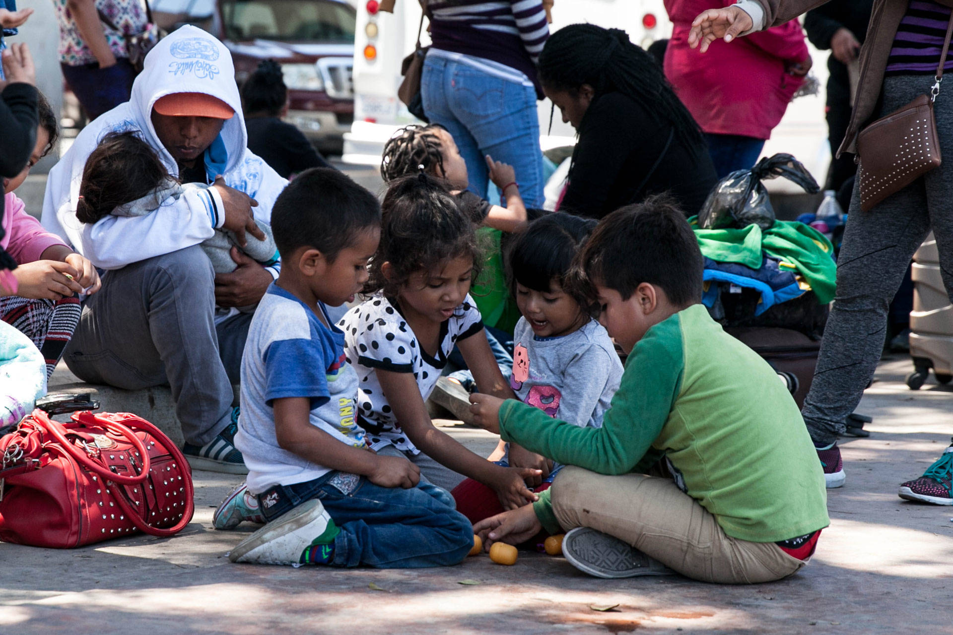 Children play as their parents wait on the Mexican side of the border, in the hopes of entering the U.S. legally by applying for asylum. The families waiting underwent arduous journeys from multiple continents, many spending their life savings to get here. Ariana Dreshler/KQED
