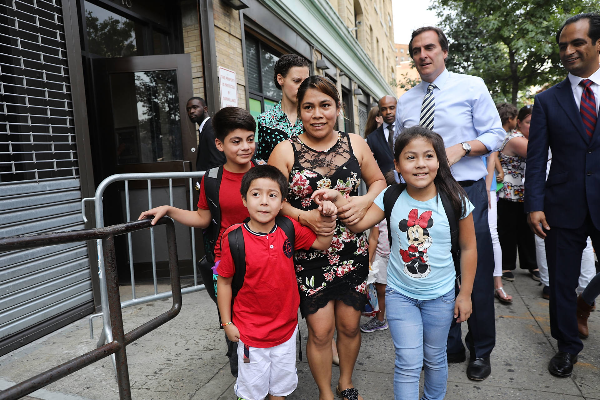 Yeni Maricela Gonzalez Garcia (center) stands with her children 6 year-old Deyuin (left), 9 year-old Jamelin (right) and 11 year-old Lester (back) as she and her lawyer speak with the news media after she was reunited with her children at the East Harlem Cayuga Centers on July 13, 2018 in New York City. Gonzalez Garcia, from Guatemala, drove cross-country to be reunited with her three children after they were taken from an Arizona immigration facility over eight weeks ago. Gonzalez Garcia crossed over the U.S. border with her three children on May 19, only two days before they were taken from her as part of President Donald Trump's controversial zero-tolerance policy of removing immigrant children from their parents after they are detained. Spencer Platt/Getty Images