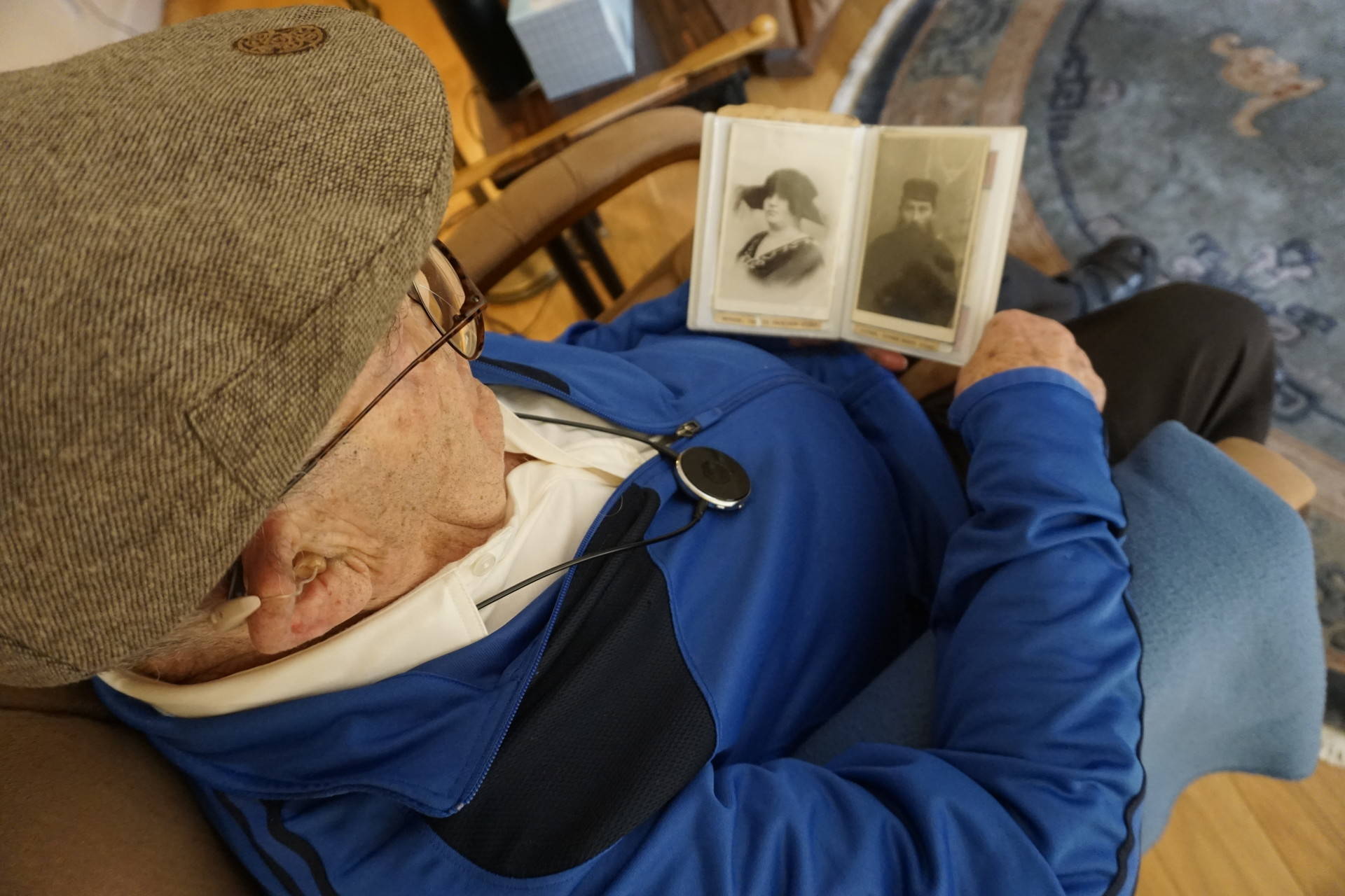 Ben Stern looks at the few remaining photographs of his parents, saved by the only one of his siblings to survive the Holocaust. Sasha Khokha/KQED