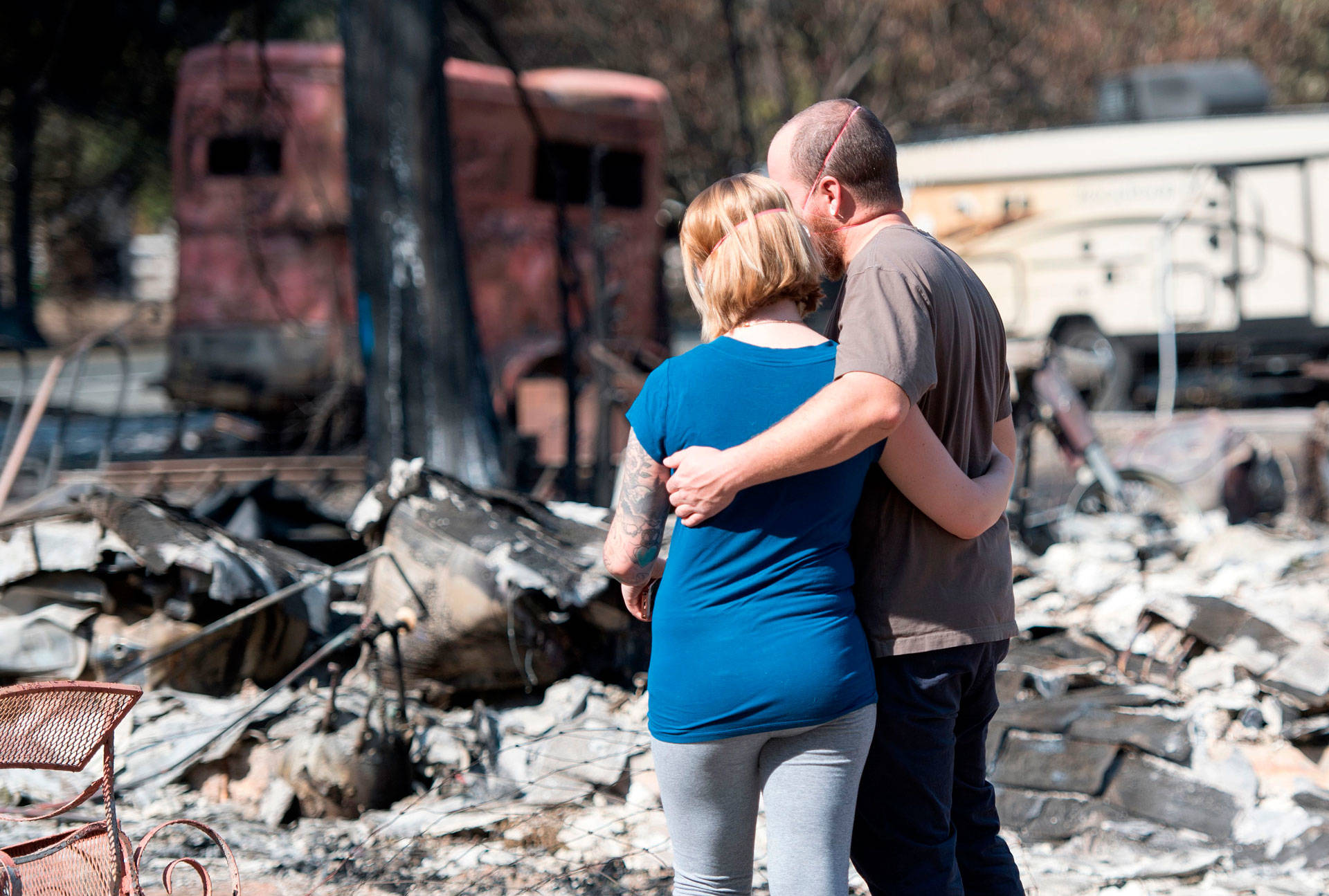 Mandi and Lane Summit embrace in front of their fire-destroyed home in the Mendocino County community of Redwood Valley on Oct. 15, 2017. Cal Fire determined the Redwood Fire started in two locations and was caused by trees or parts of trees falling onto PG&amp;E power lines. JOSH EDELSON/AFP/Getty Images
