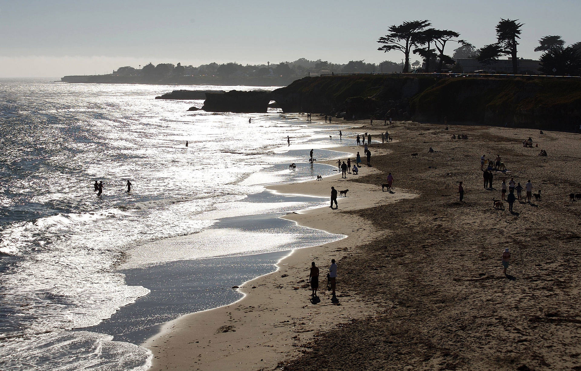 Visitors in Santa Cruz enjoy the beach below West Cliff Drive. Santa Cruz County has the second-highest poverty rate in the state, after Los Angeles. Stephen Dunn/Getty Images