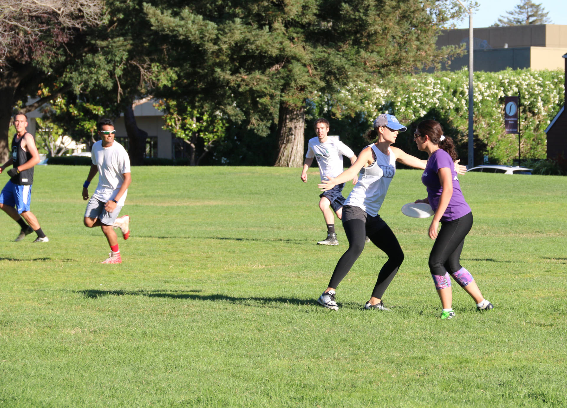 Afifa Tawil is an organizer of pickup ultimate games in the South Bay. Here she eyes opportunities to pass the Frisbee.  Olivia Allen-Price/KQED