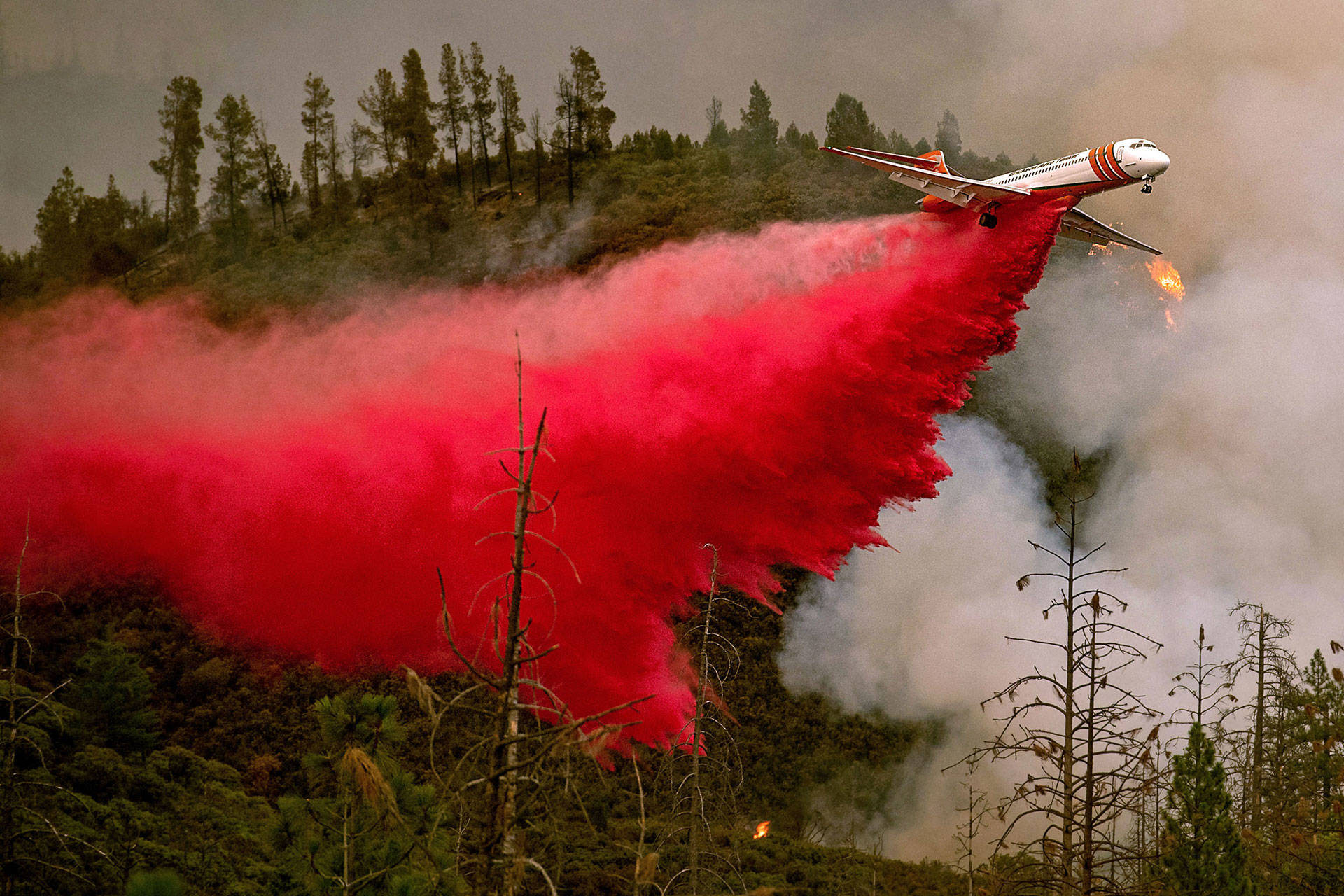 An air tanker drops retardant while battling the Ferguson Fire near Yosemite National Park on July 21. The fire is now burning within the park boundary. NOAH BERGER/AFP/Getty Images