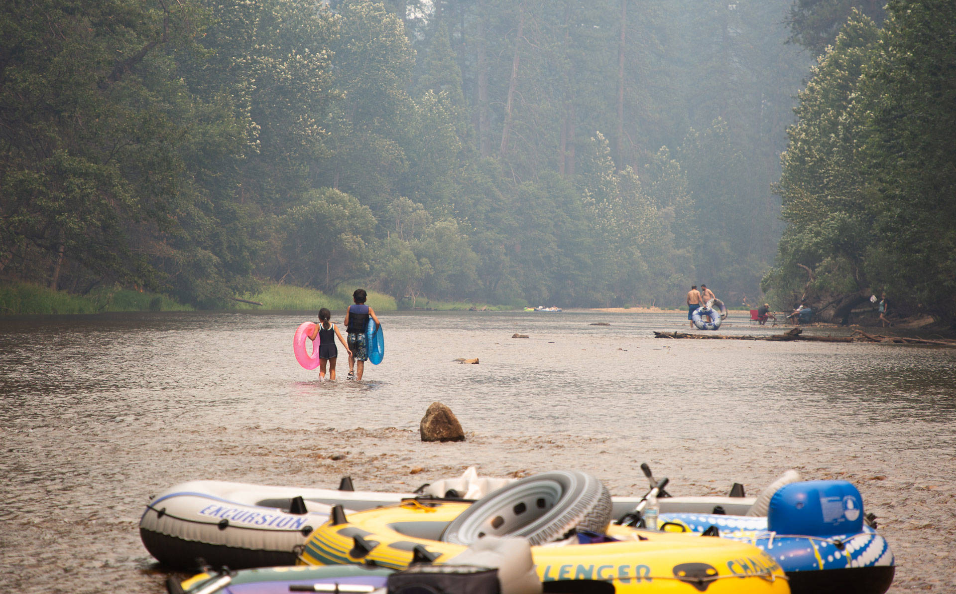 Yosemite National Park-goers raft in the Merced River just before the Yosemite Valley closed in July due to the Ferguson Fire. Samantha Shanahan/KQED
