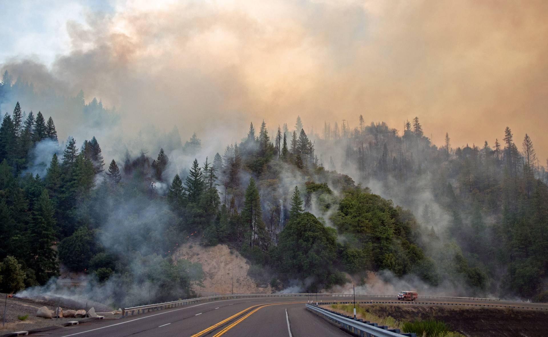 A fire truck drives along Highway 299 as the Carr Fire continues to burn near Whiskeytown, California, on July 28, 2018. JOSH EDELSON/AFP/Getty Images
