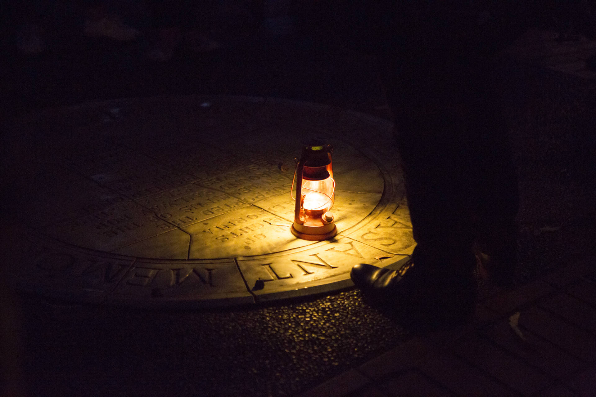 A lantern illuminates the sidewalk plaque dedicated to Mary Ellen Pleasant on the San Francisco Ghost Hunt tour Anne Wernikoff / KQED
