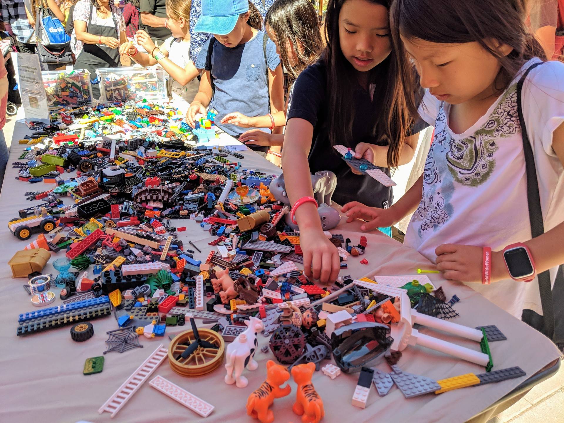 Two girls explore the Lego station at the 'makerspace' at the Girls' Festival. In addition to the makerspace, the festival featured panels and workshops, including a 'Girlpreneur' pitch competition. 'I liked how the girls like came up with their own business ideas... these girls they take chances and risks to do what they want,' said 11-year-old attendee Riley Wilson. Muna Danish/KQED
