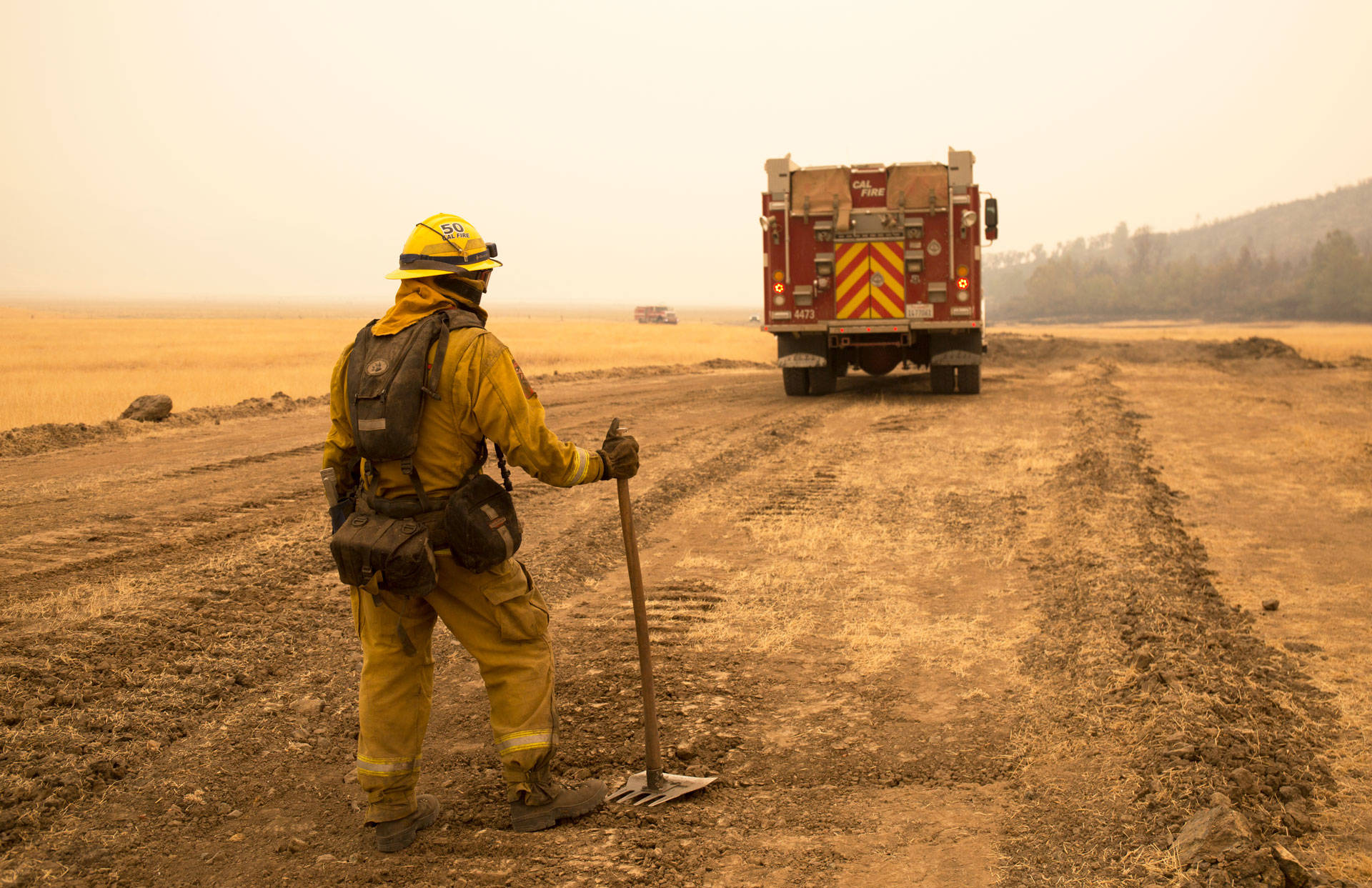 A Cal Fire firefighter watches for spot fires from a controlled burn at the edge of the Ranch Fire in 2018. Anne Wernikoff/KQED