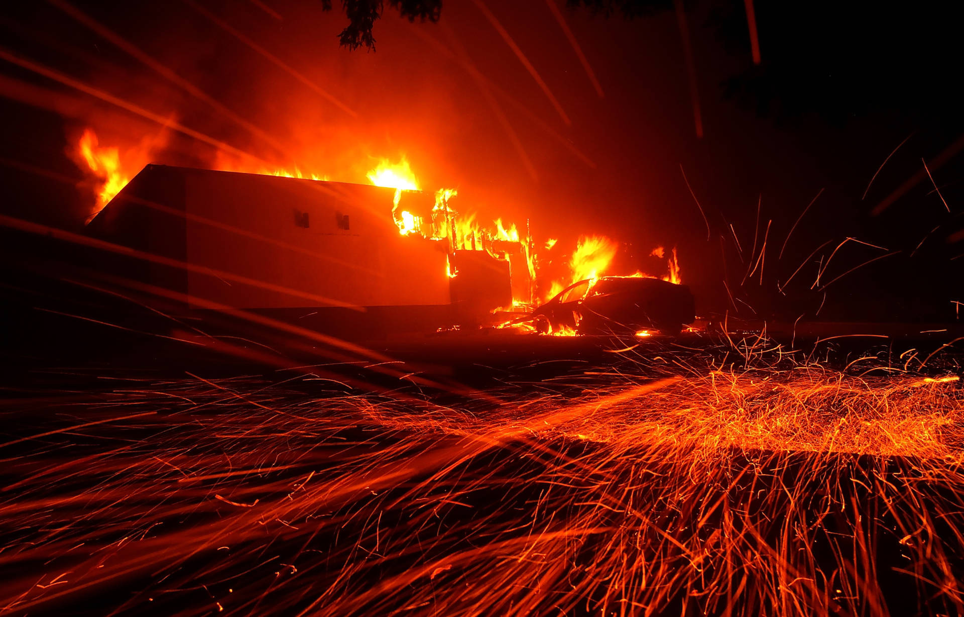 Embers blew in the wind as the Camp Fire burned a KFC restaurant Thursday night in the Butte County town of Paradise. Justin Sullivan/Getty Images