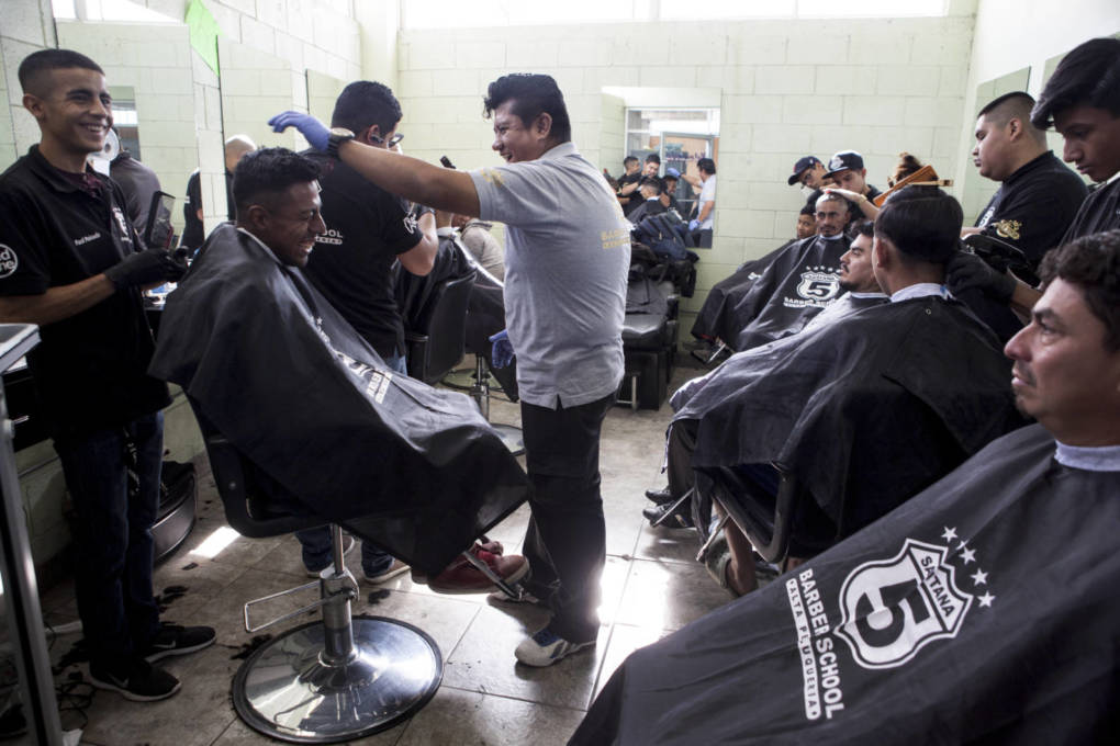Thousands of Central American migrants traveling together through Mexico to reach the U.S. border arrived in Tijuana Thursday, Nov. 15, 2018. At a Catholic center called Padre Chava, migrants received breakfast and free haircuts from students of Santana 5 Barber School. The school has provided free haircuts at the shelter for years.   Erin Siegal McIntyre/KQED