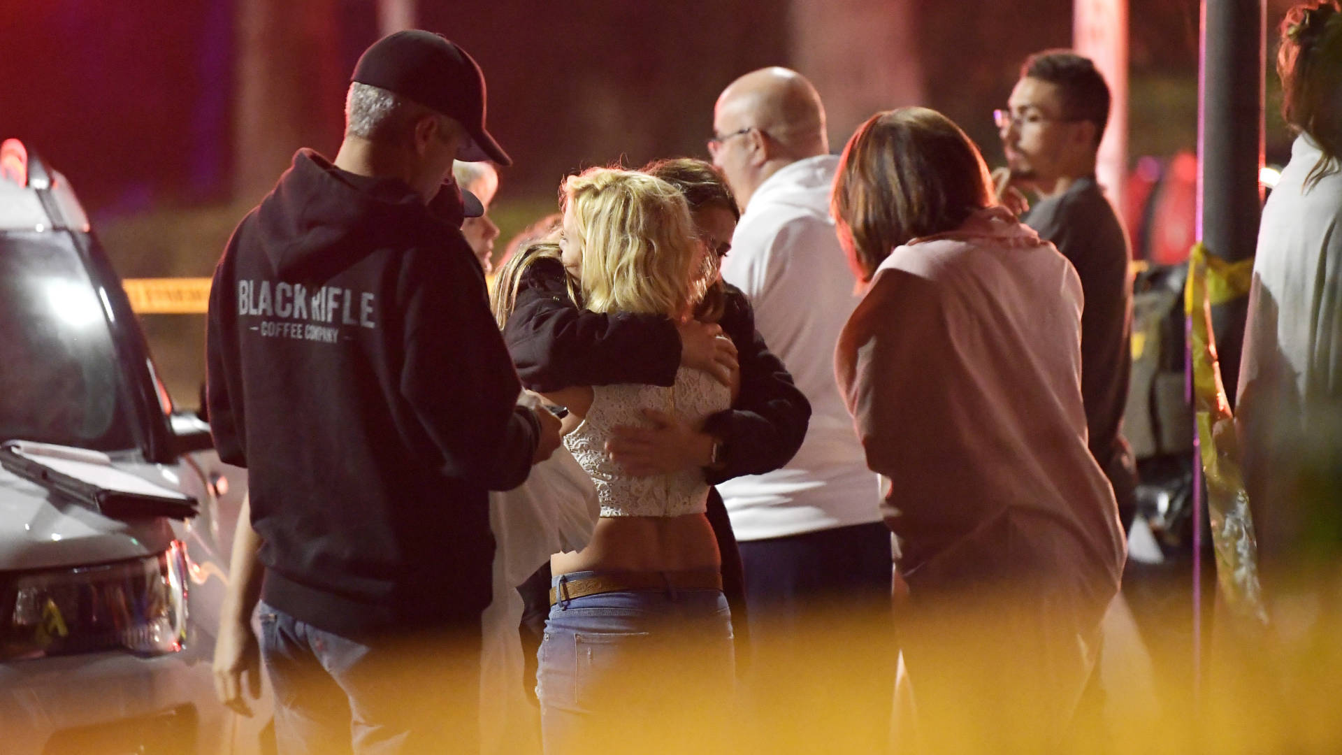 People comfort each other outside a bar in Thousand Oaks, where a gunman opened fire and killed 12. Mark J. Terrill/AP