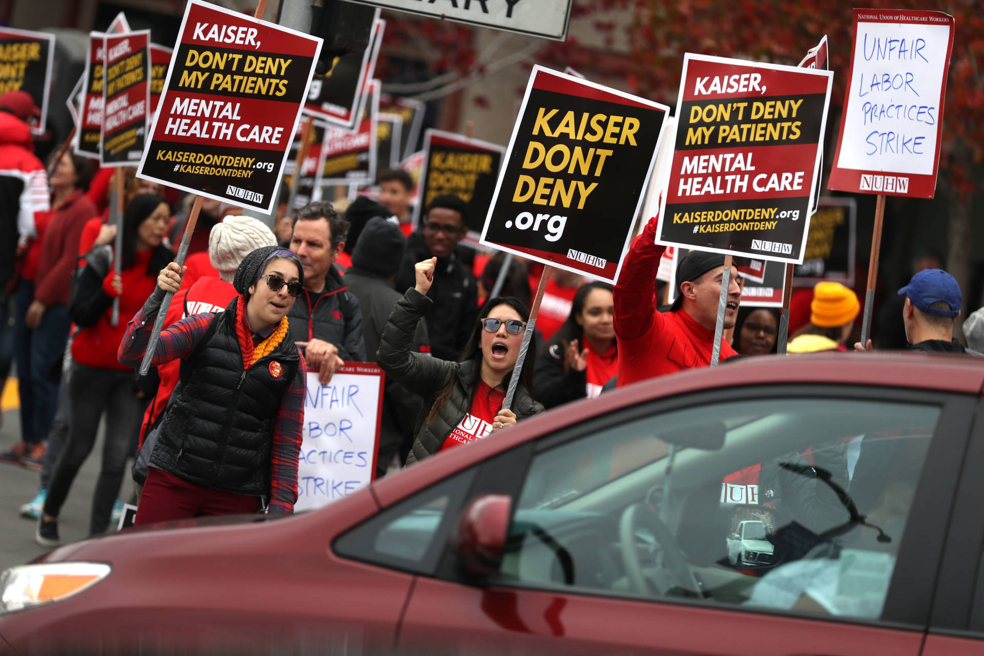 Kaiser Permanente mental health workers carry signs as they march in front of Kaiser Permanente San Francisco Medical Center on Dec. 10, 2018, in San Francisco. Nearly 4,000 Kaiser Permanente mental health workers with the National Union of Healthcare Workers kicked off a five-day strike at Kaiser facilities throughout California. The union says they are protesting the lack of staffing that forces many patients to wait for a month or more for appointments. Justin Sullivan/Getty Images