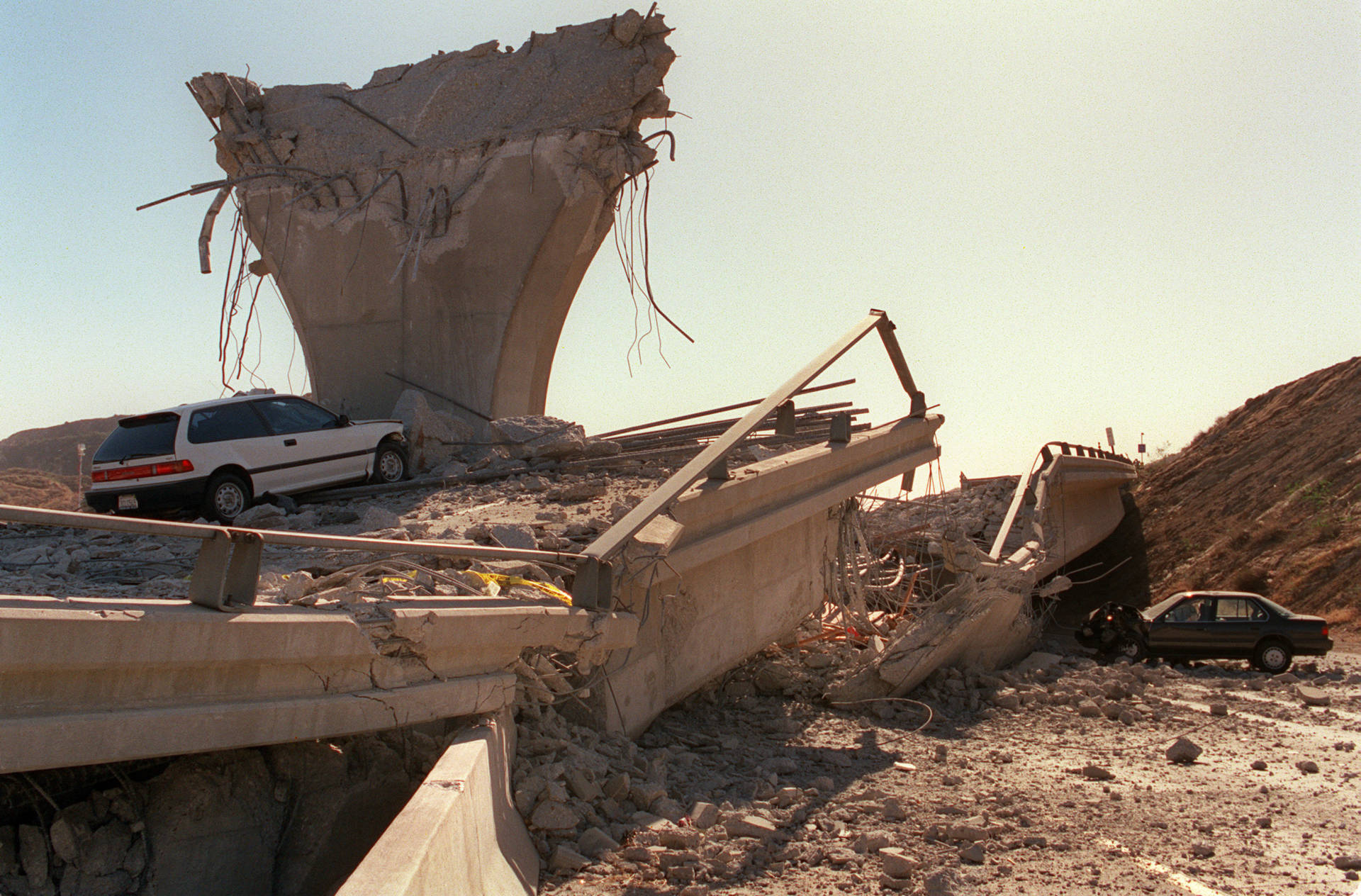 Cars lie smashed by the collapsed Interstate 5 connector few hours after Northridge earthquake, on January 17, 1994, in Sylmar, California. Jonathan Nourak/AFP/Getty Images