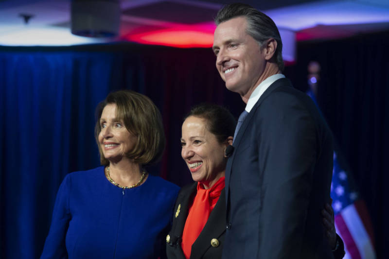 Congresswoman Nancy Pelosi, Lt. Gov. Eleni Kounalakis and Gov. Gavin Newsom stand together on stage at the Tsakopoulos Library Galleria on Monday, January 7, 2019 in Sacramento.