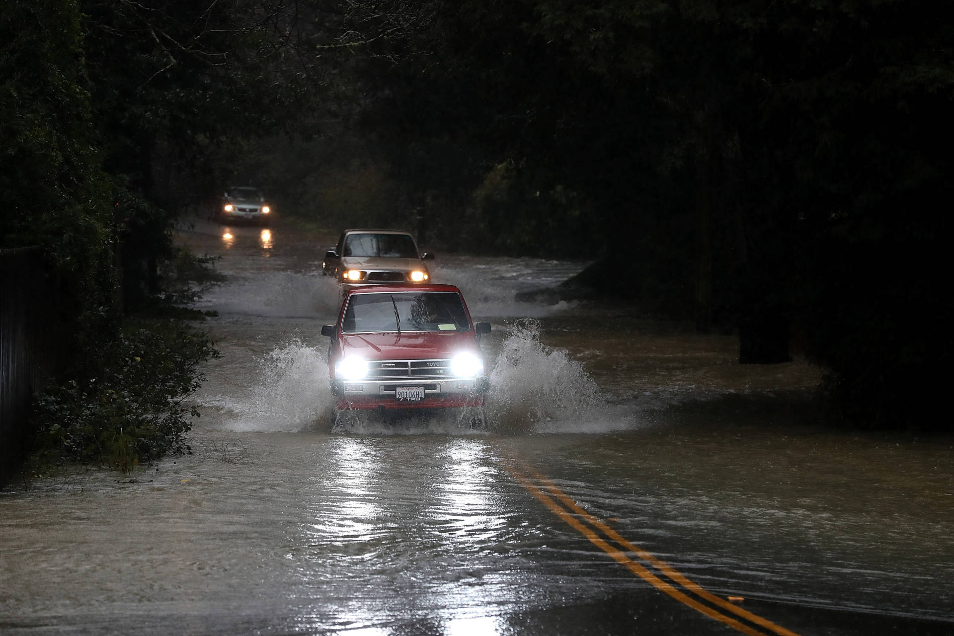 Cars drive on a flooded road in Guerneville in January 2017. The Russian River town is just downstream from Venado, a site in the northern Sonoma County hills that is one of the rainiest locations in California.  Justin Sullivan/Getty Images