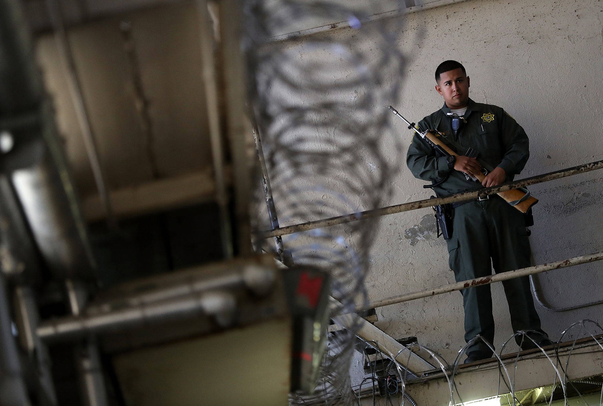 An armed California Department of Corrections and Rehabilitation (CDCR) officer stands guard at San Quentin State Prison in 2016. Justin Sullivan/Getty Images